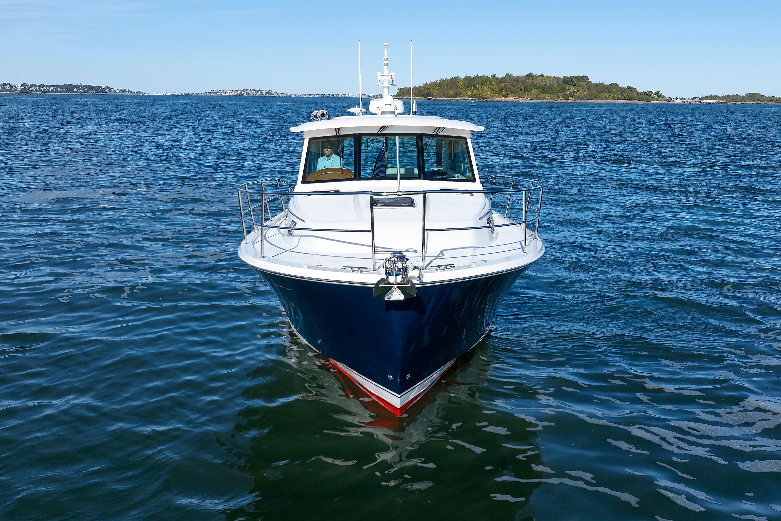 2022 Sabre 38 SE yacht on open water, front view with clear blue sky.