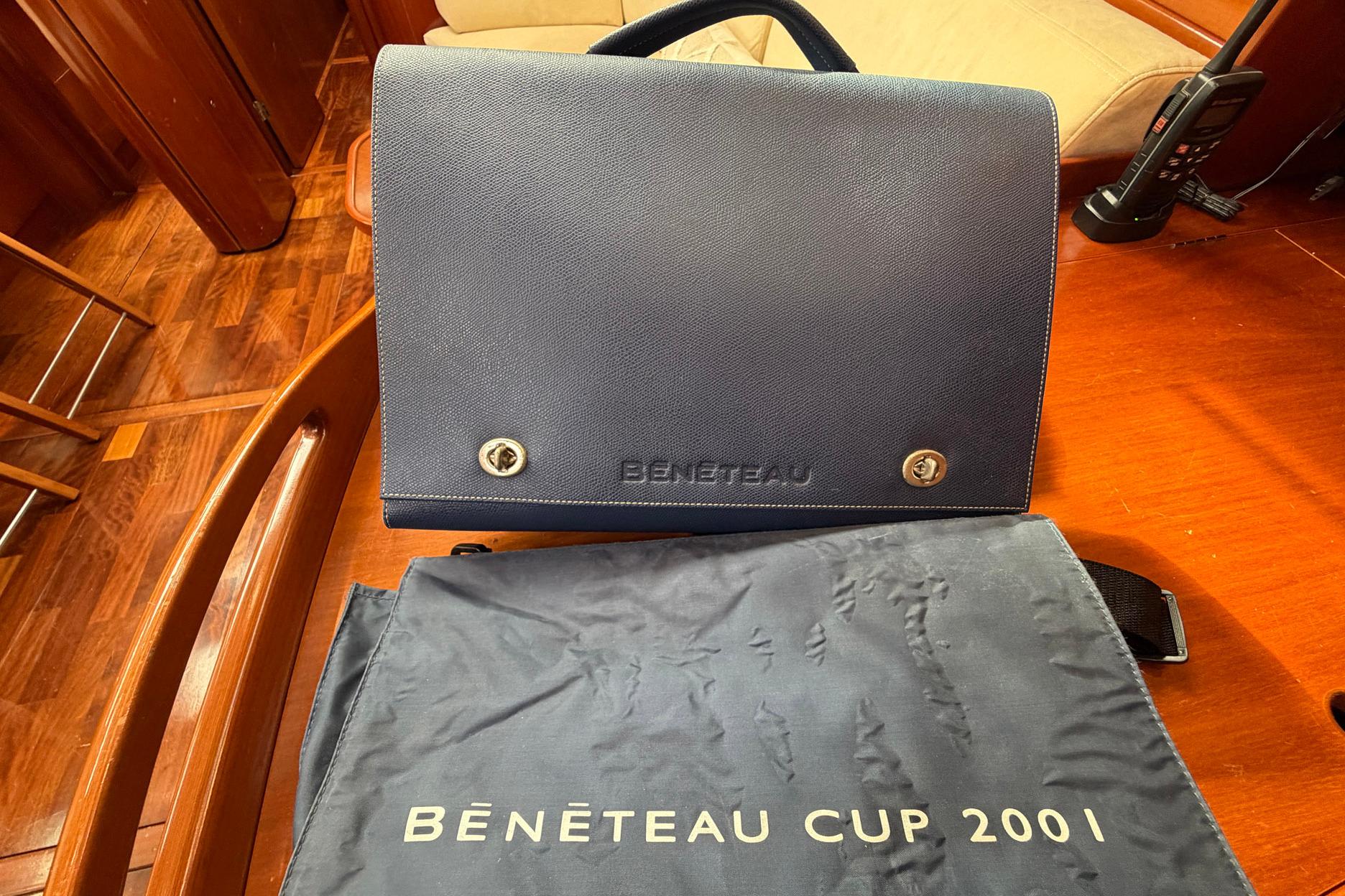 Beneteau 57 yacht interior with branded bag and Beneteau Cup 2001 cover.