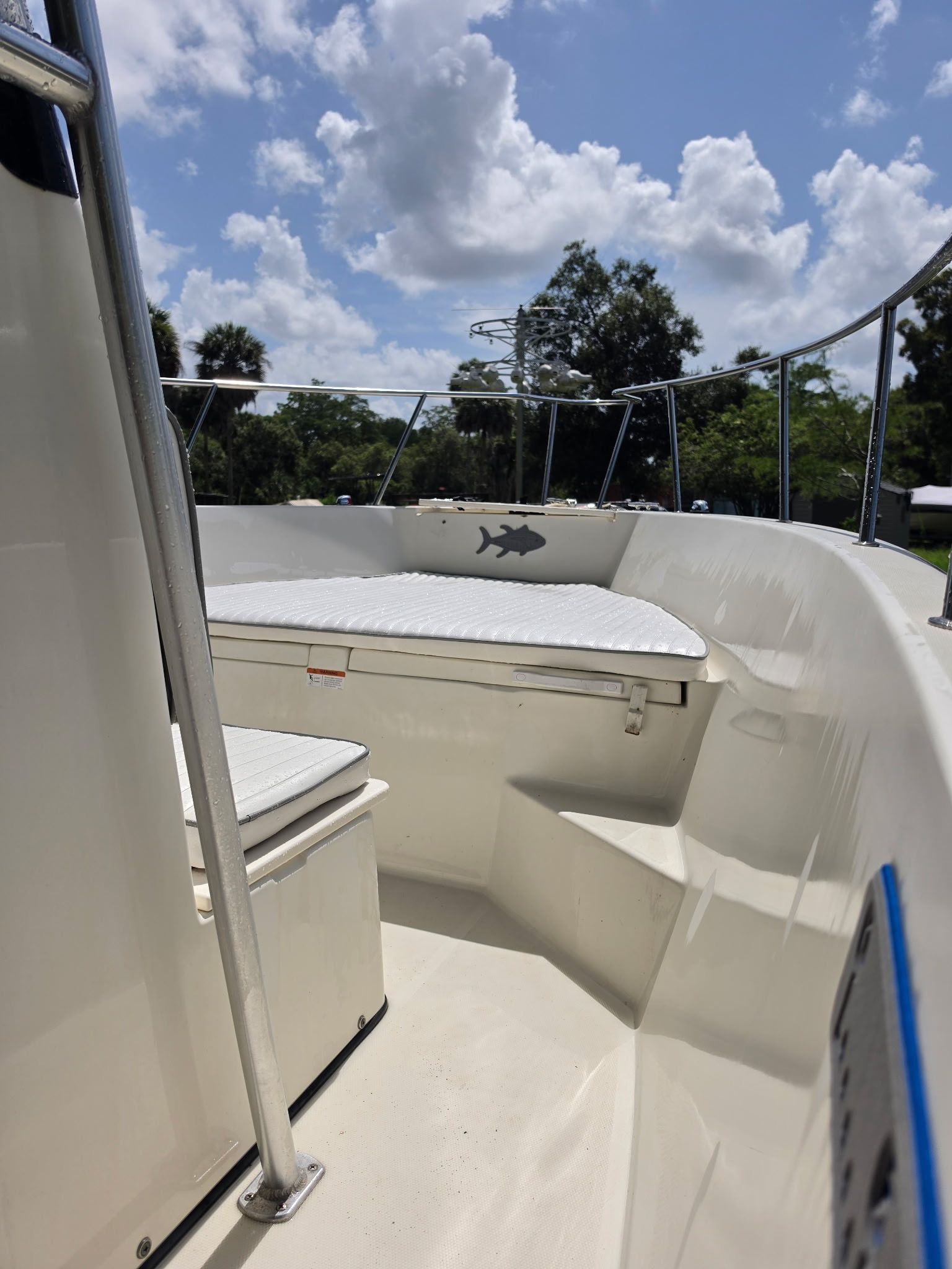 2004 Hydra-Sports Lightning 230 CC with spacious deck and seating area under a blue sky.