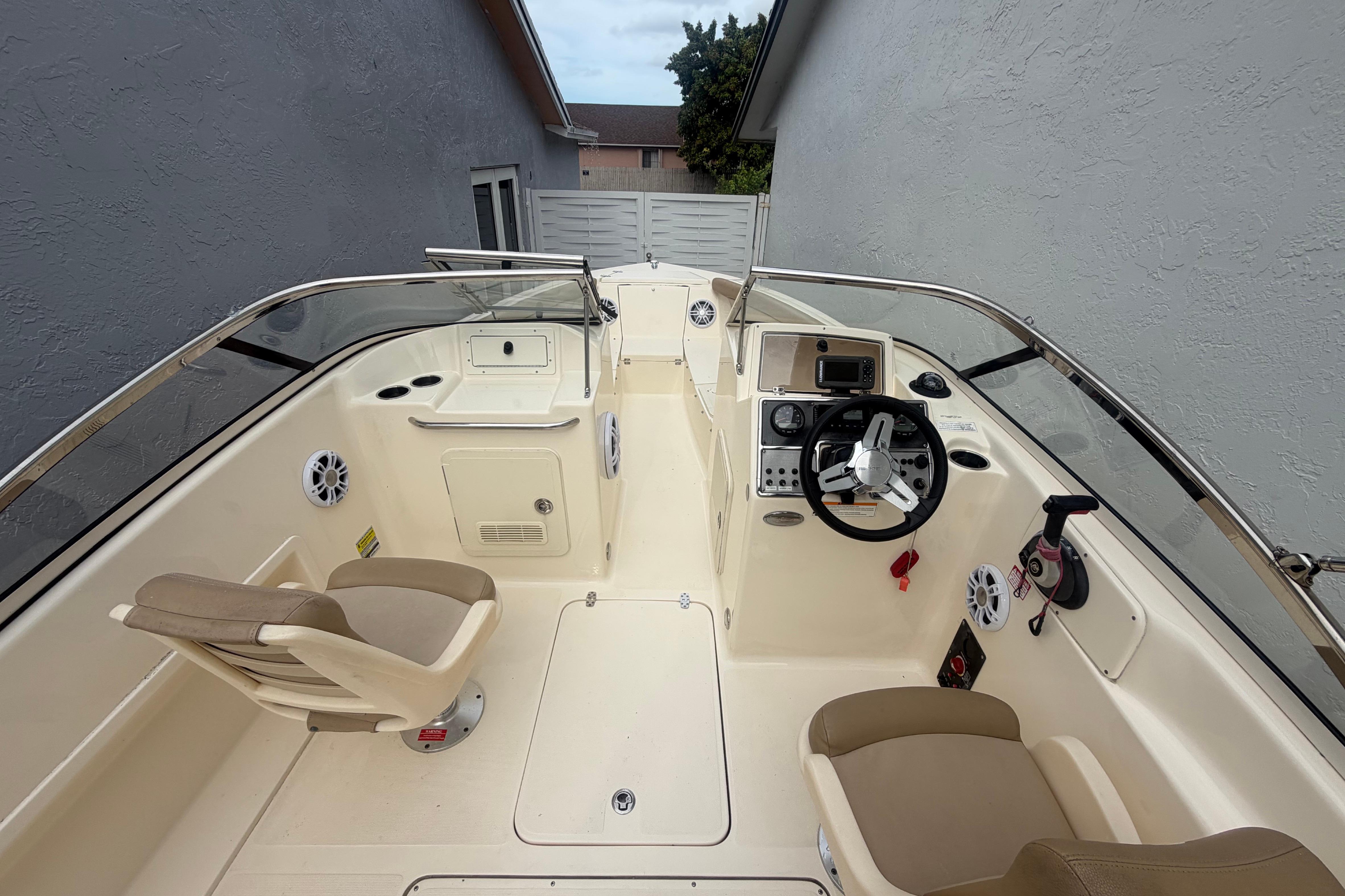 2023 Scout 210 Dorado boat interior with steering wheel and seating.