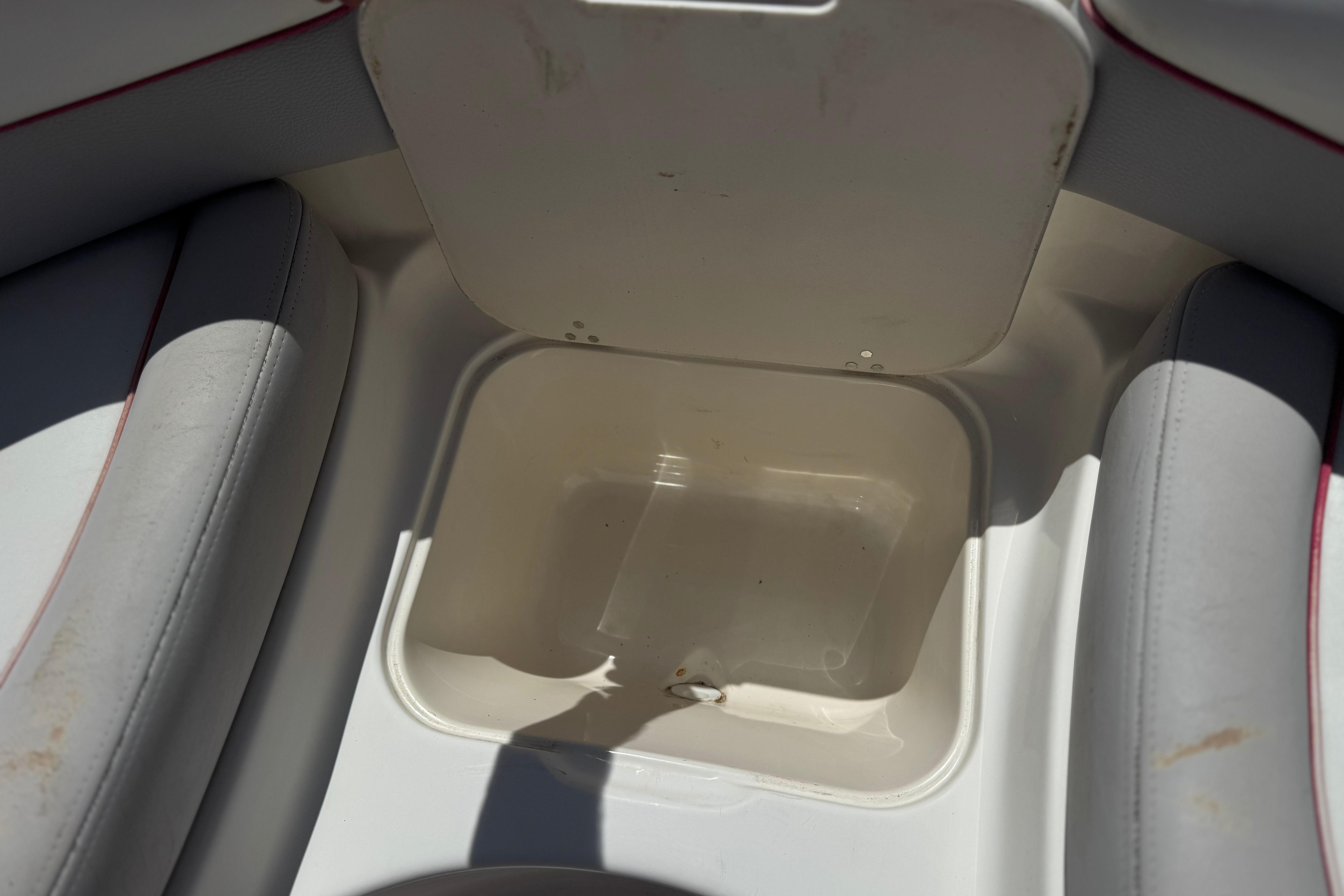 Open storage compartment in a 2010 Bryant 255 boat interior.