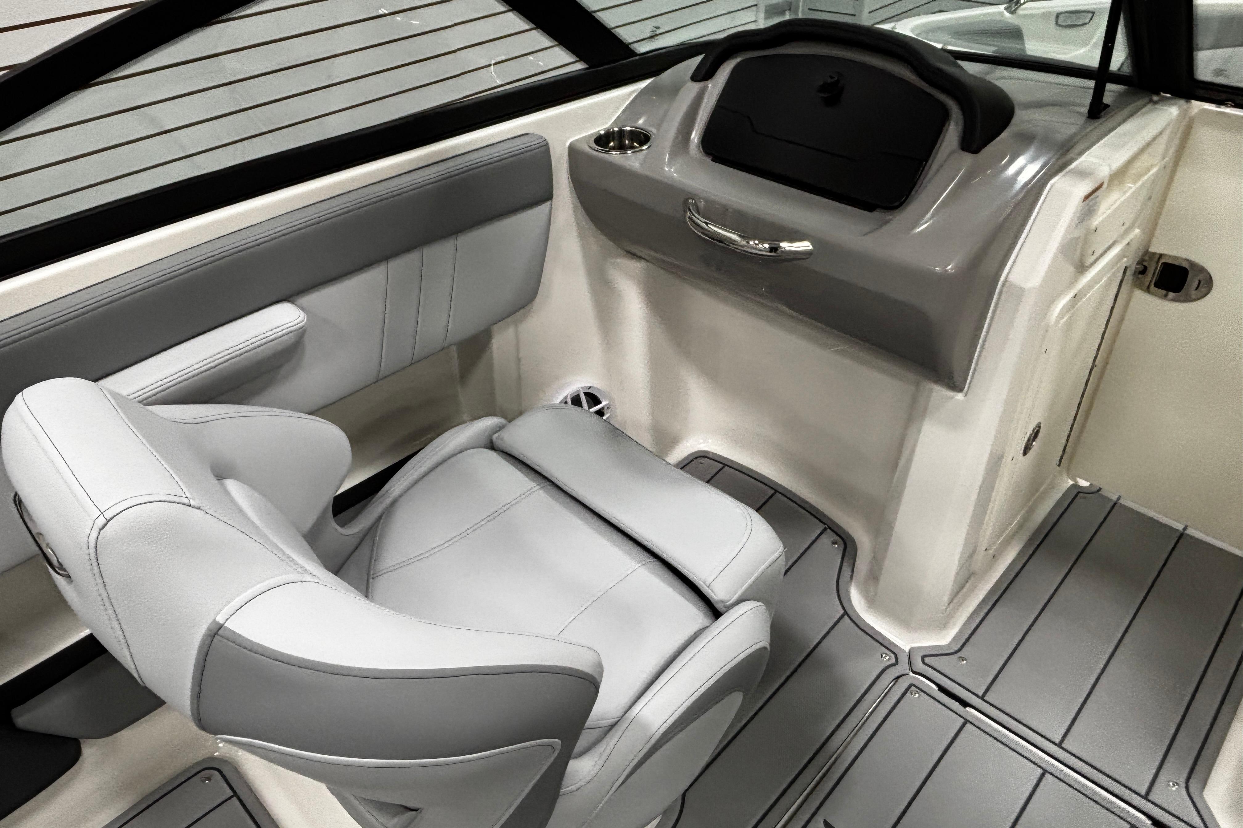2026 Chaparral 21 SSi boat interior with gray seating and sleek dashboard design.