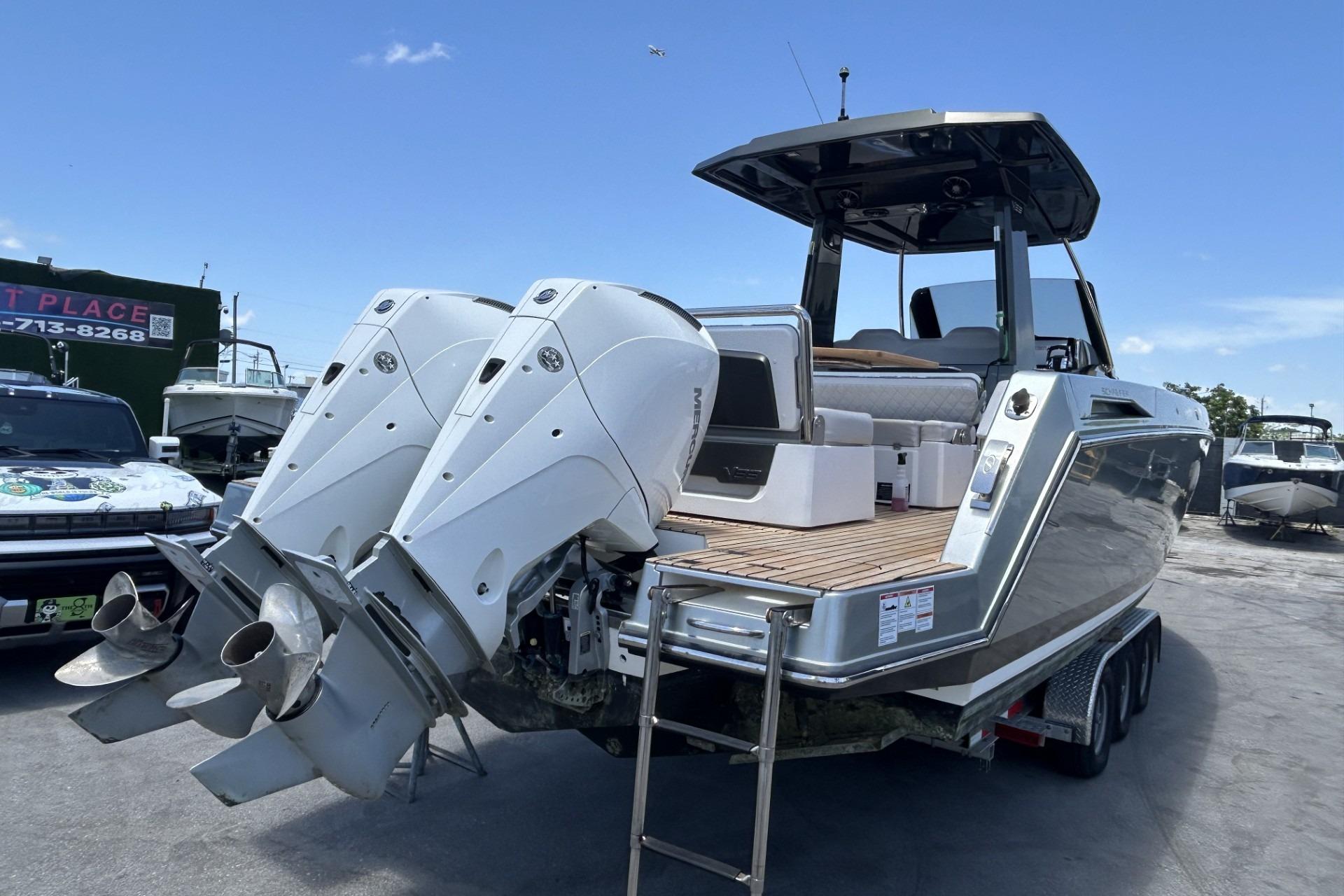 2023 Schaefer V33 boat with dual outboard motors on a trailer, ready for transport.