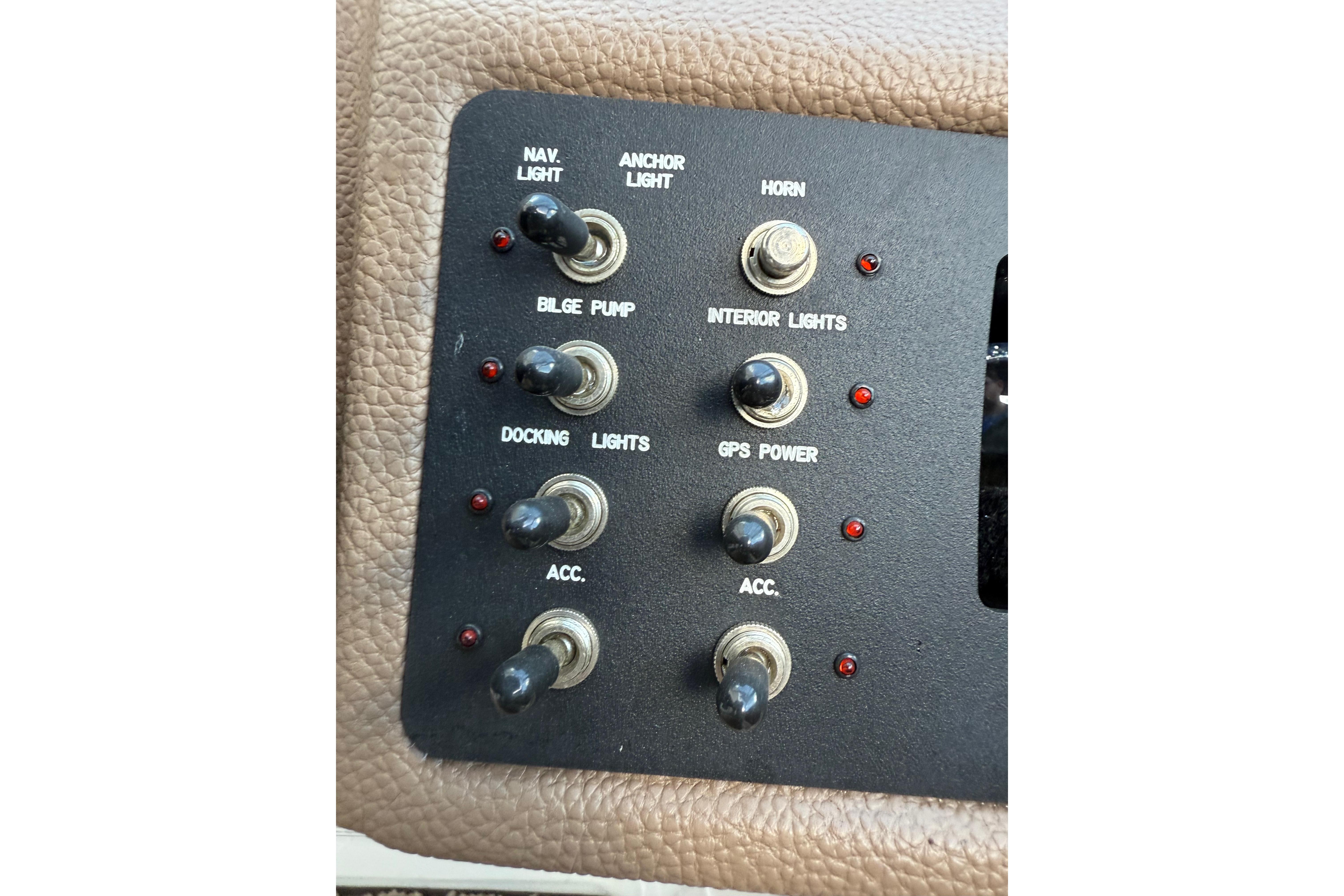 Control panel of a 2015 Cobalt 200 boat with various switches and indicators.