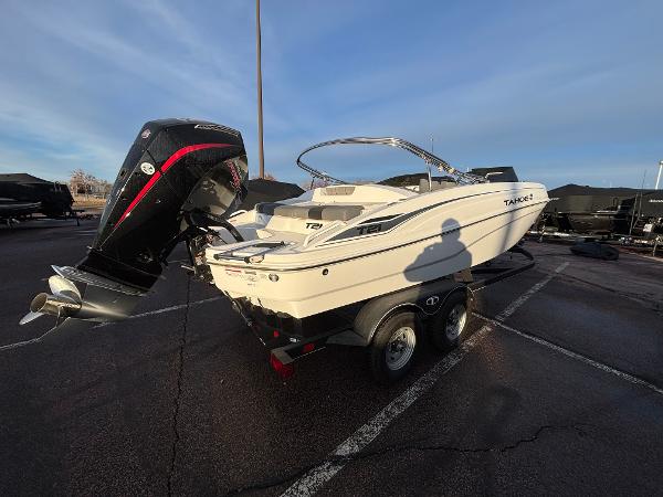 2024 Tahoe T21 boat on trailer in parking lot, rear view.
