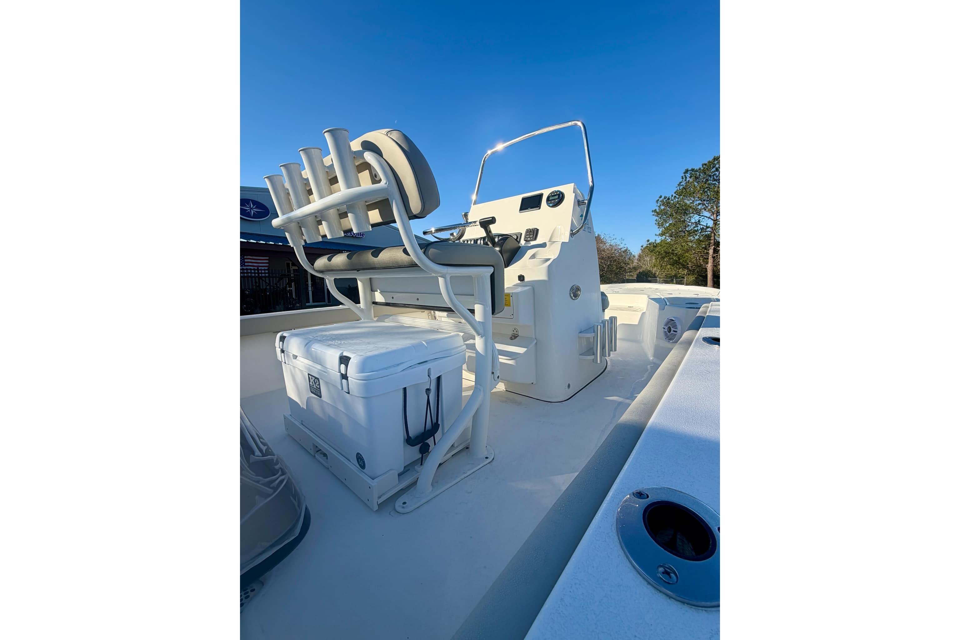 2026 Key West 210 Bay Reef boat interior with seating and cooler, under clear blue sky.