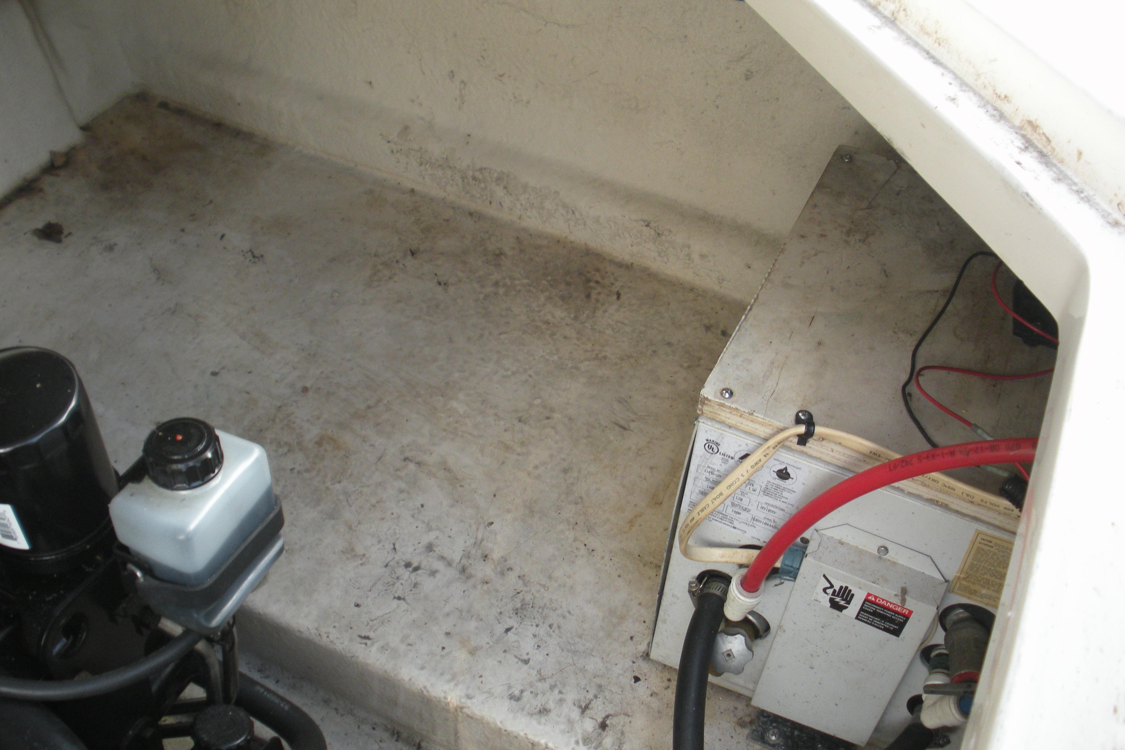 Engine compartment of a 2000 Sea Ray 240 Sundancer boat, showing mechanical components.