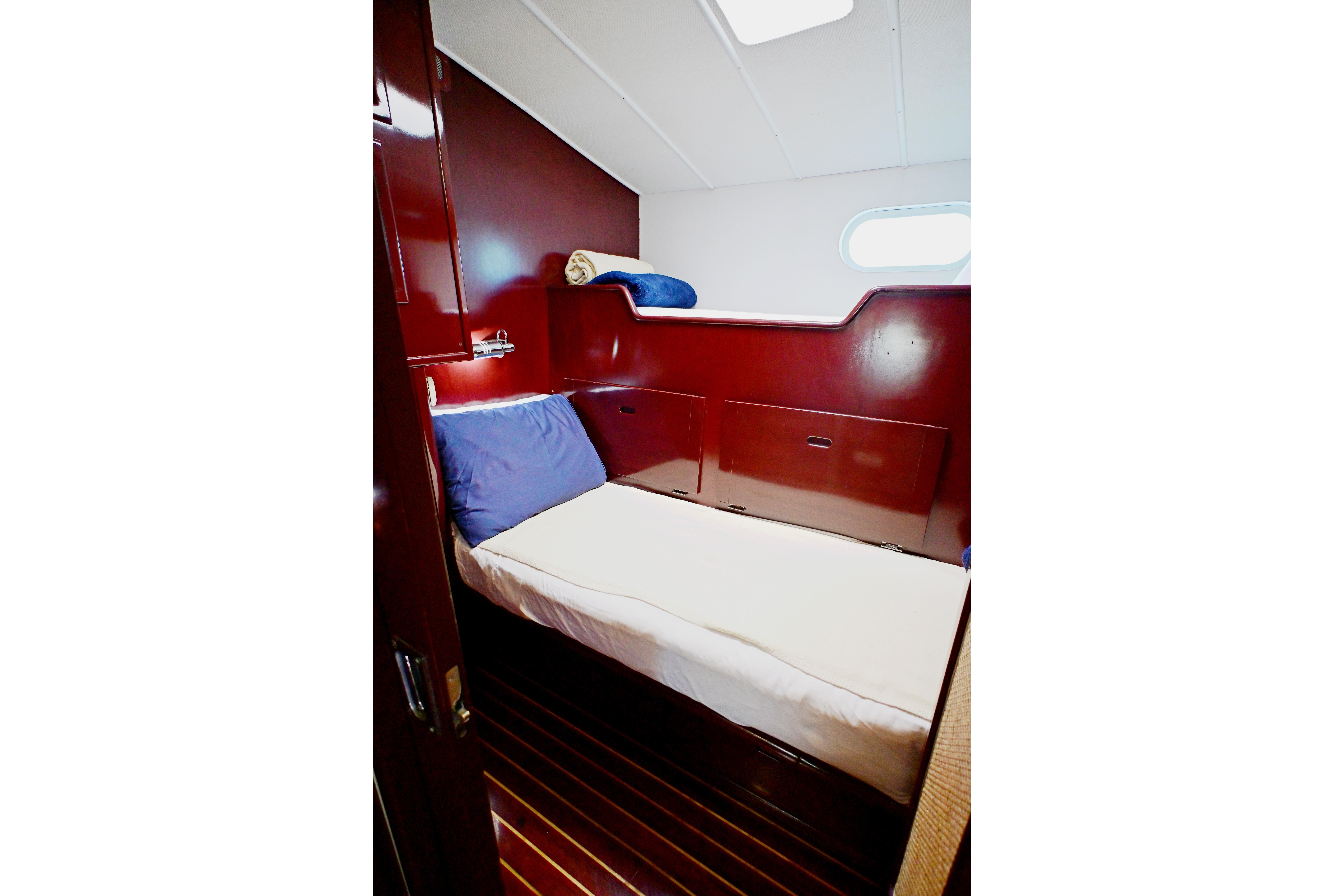 Cozy cabin interior of 1968 Abeking & Rasmussen Tripp 74 yacht with wooden finish.