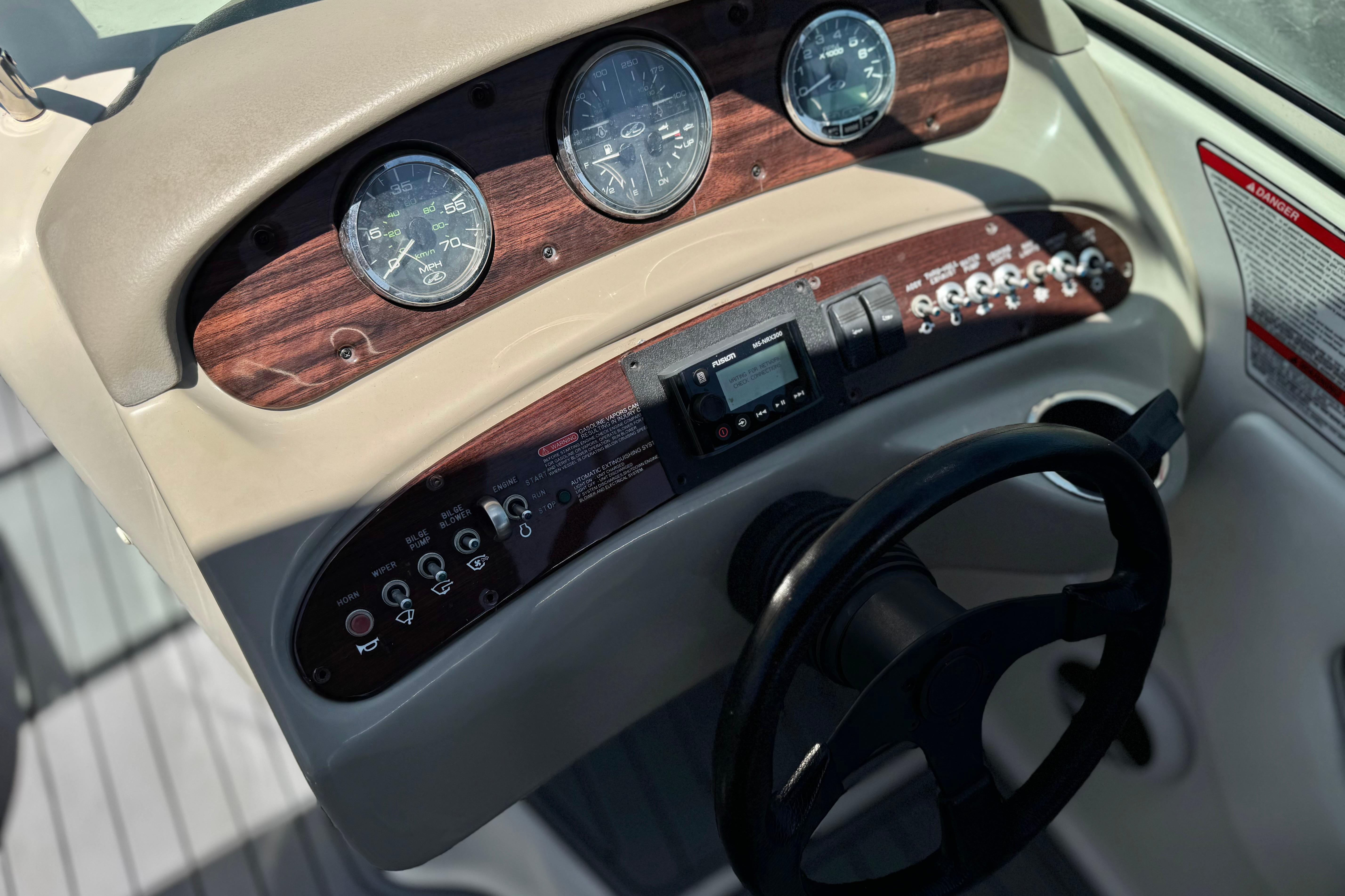 Dashboard of a 2007 Sea Ray 240 Sundeck boat with gauges and controls.