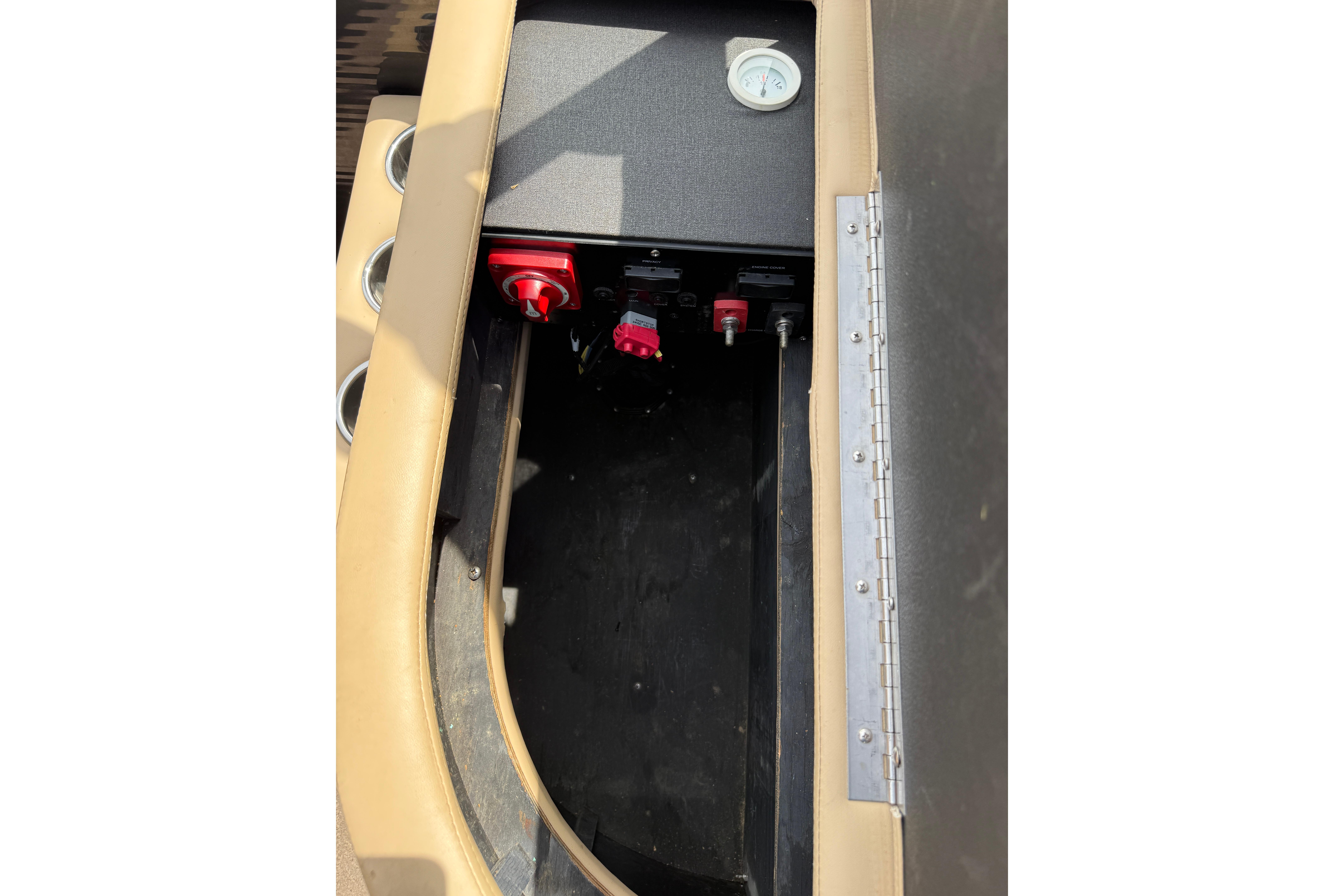 Storage compartment of a 2011 Bennington 2575QCW I/O boat with control switches.