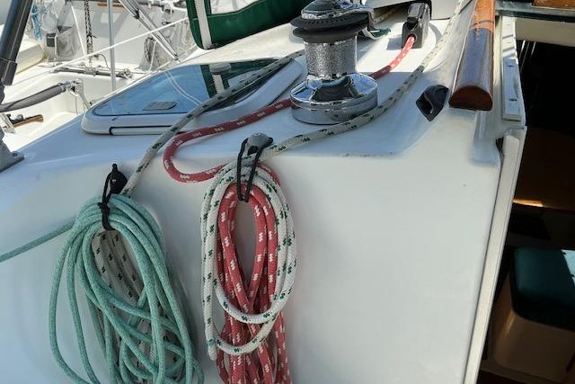 Deck of 2000 Beneteau Oceanis 321 sailboat with ropes and winch.