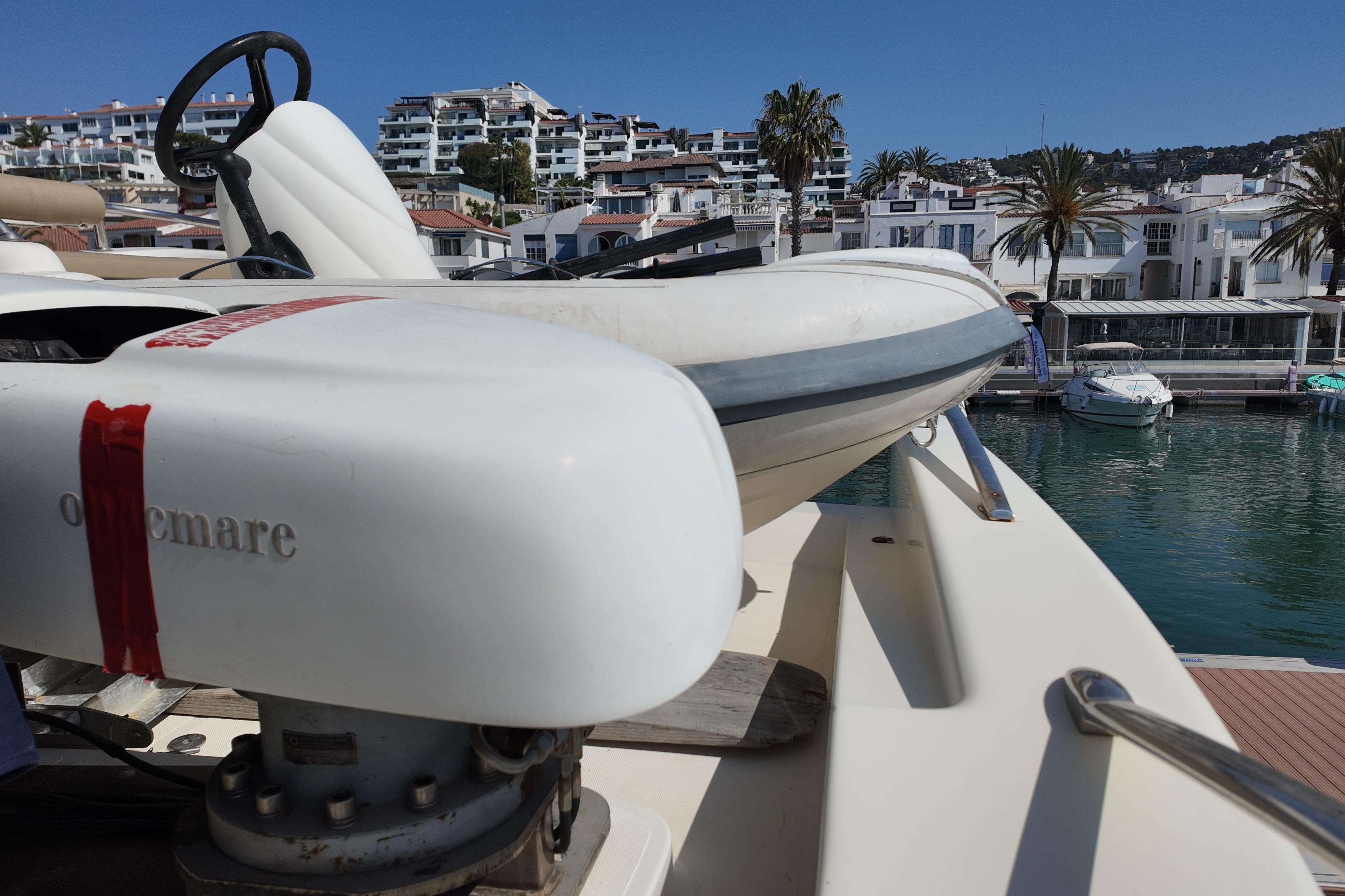2006 Azimut 68E yacht with tender, docked in a scenic marina.