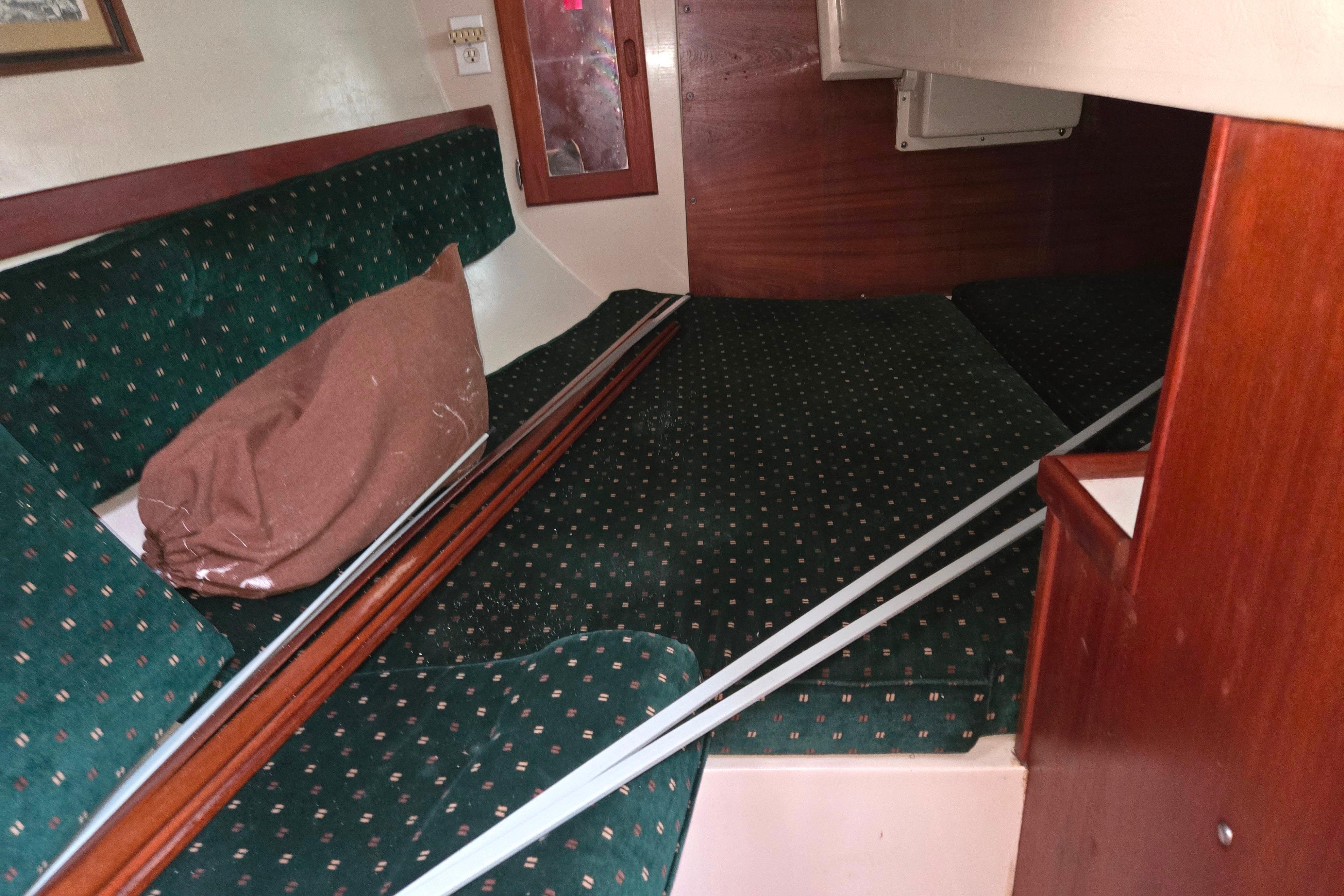 Interior cabin of a 1986 Catalina 355 sailboat with green upholstery.