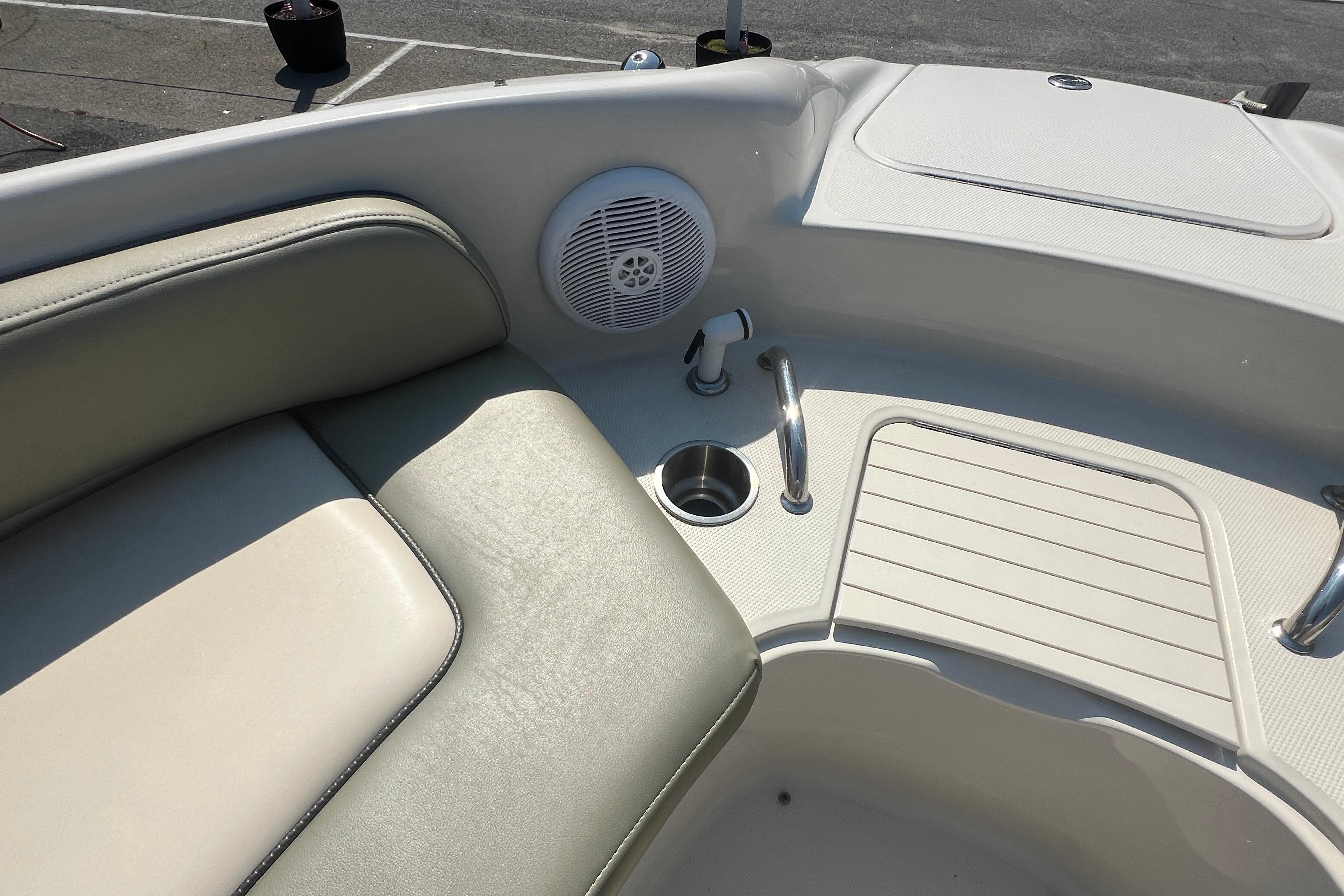 Interior of a 2005 Sea Ray 240 Sundeck boat, featuring seating and speaker.