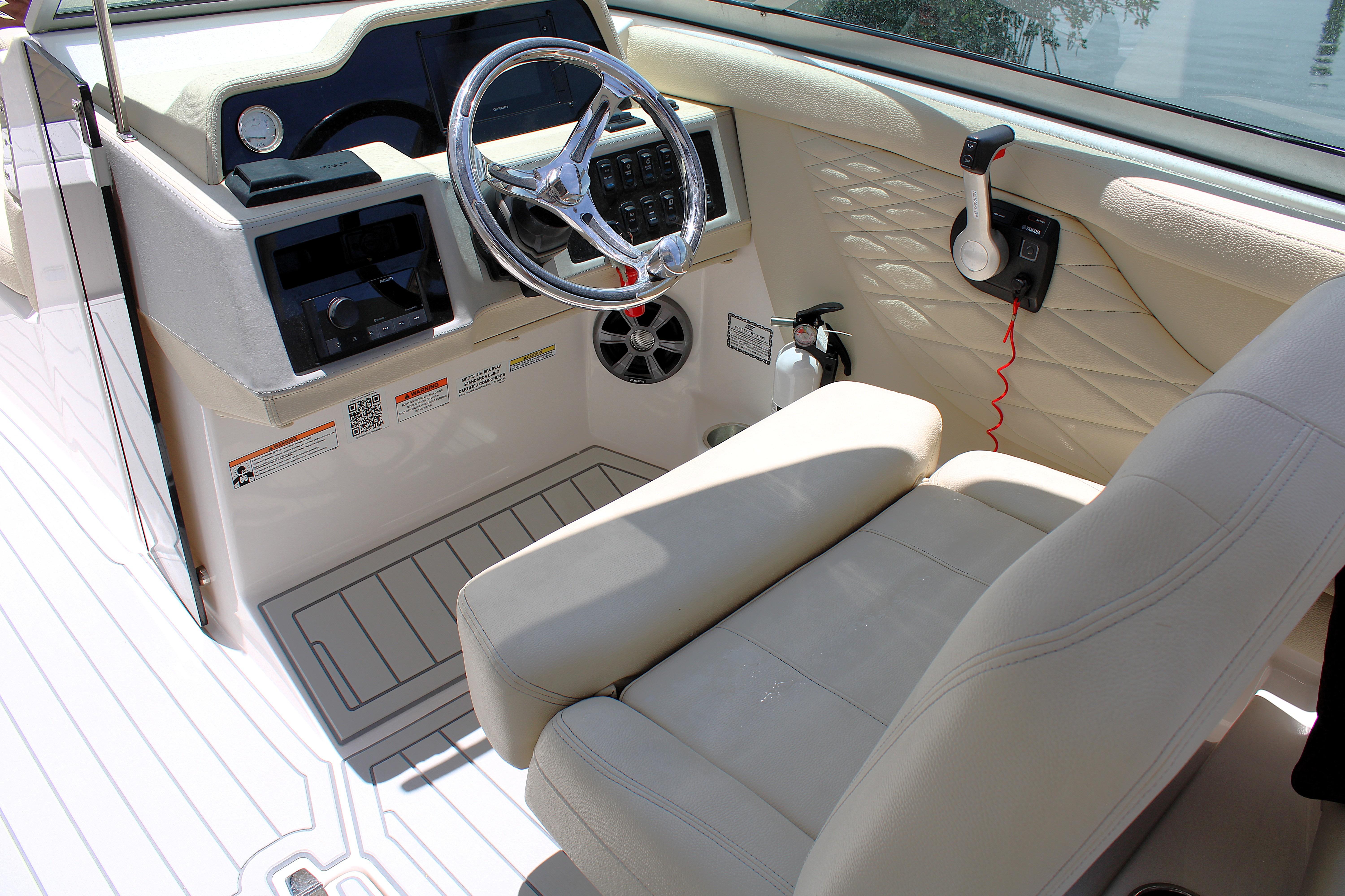2021 Regal 26 OBX boat cockpit with steering wheel and control panel.