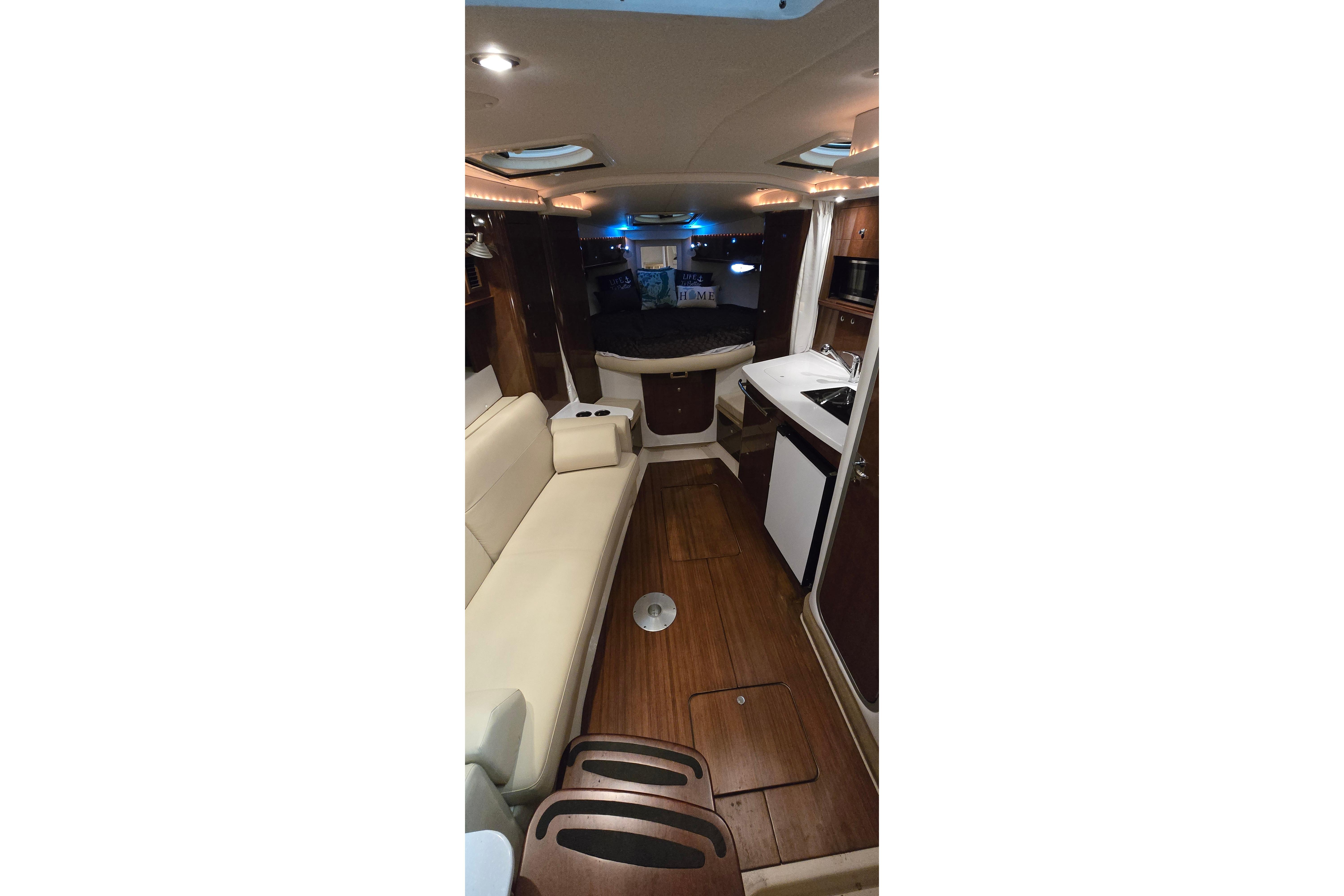 Interior of 2018 Four Winns V355 yacht with modern seating and kitchenette.