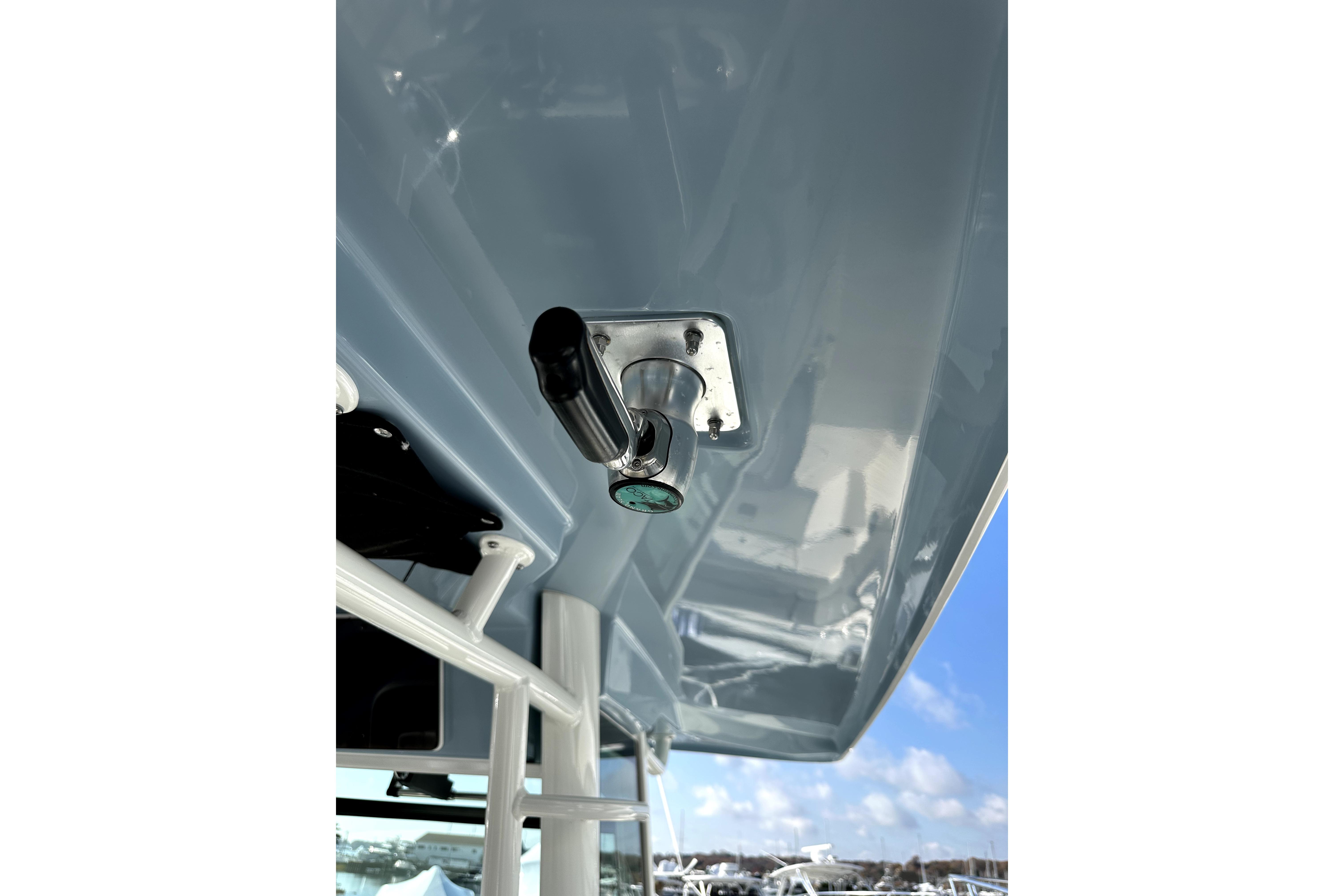 2023 Boston Whaler OUTRAGE boat detail with stainless steel fitting under blue sky.