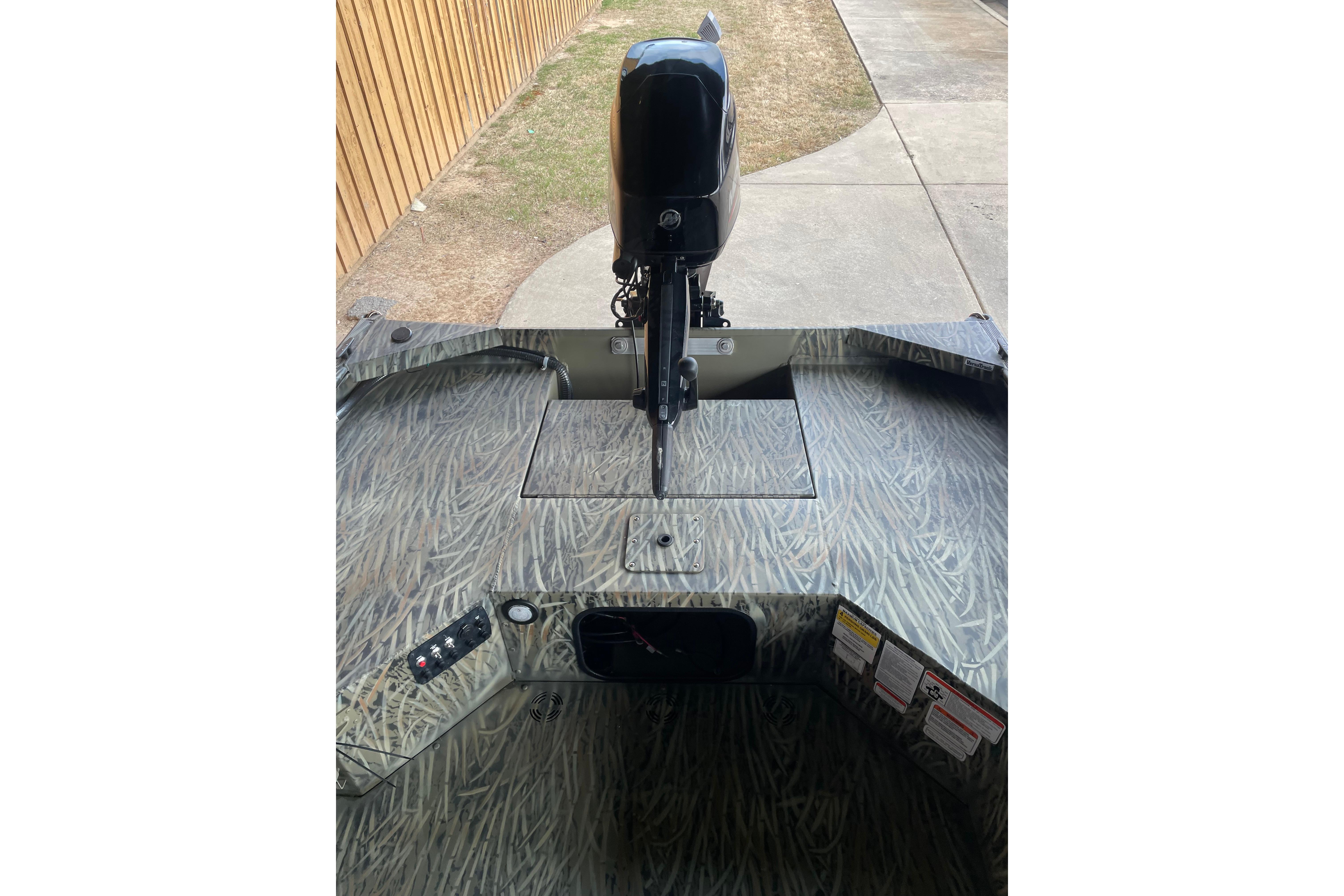 2026 Tracker Grizzly 1654 T Sportsman boat with camo pattern and outboard motor.