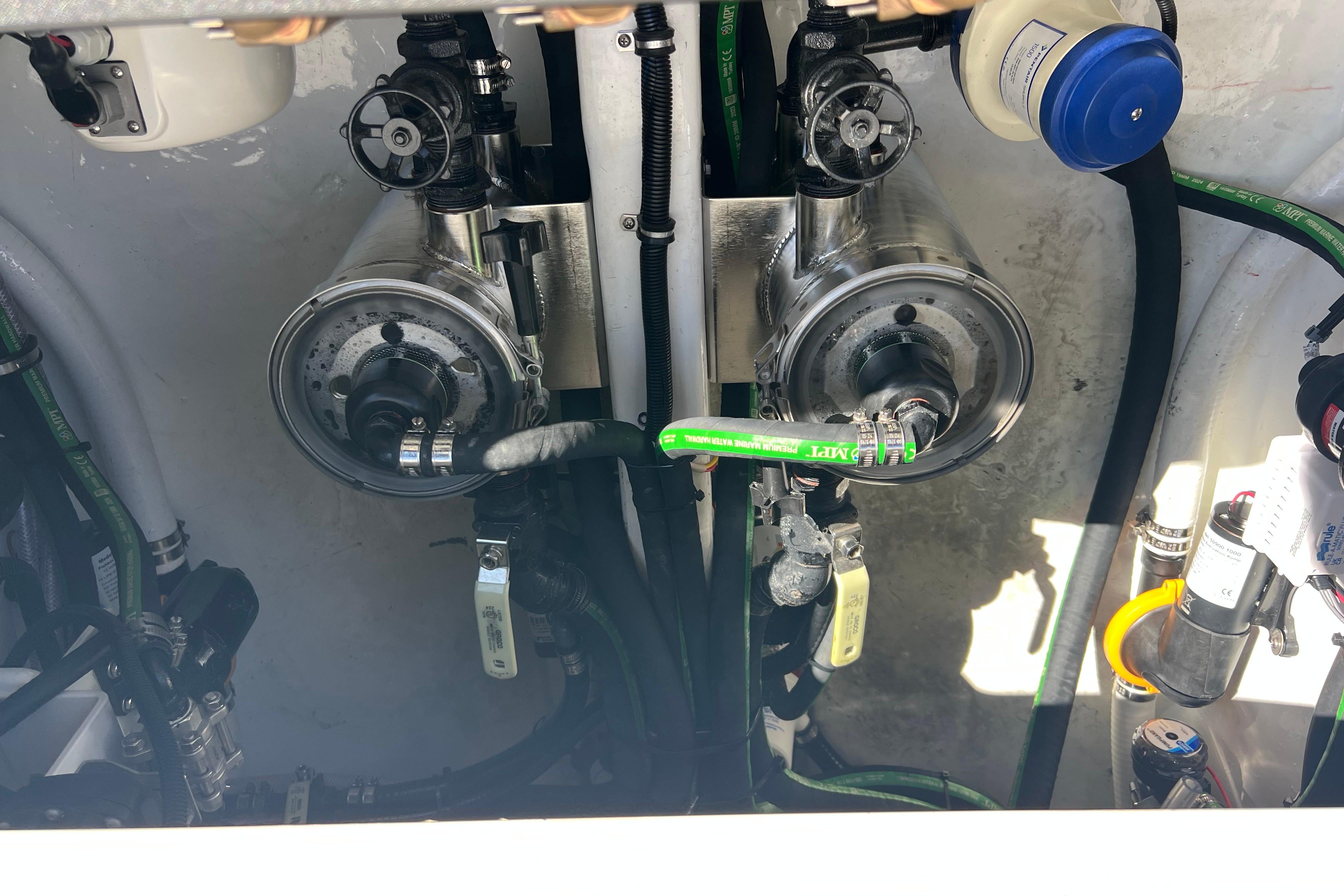 Engine compartment of 2026 Nor-Tech 450 Sport boat, showcasing mechanical components and hoses.