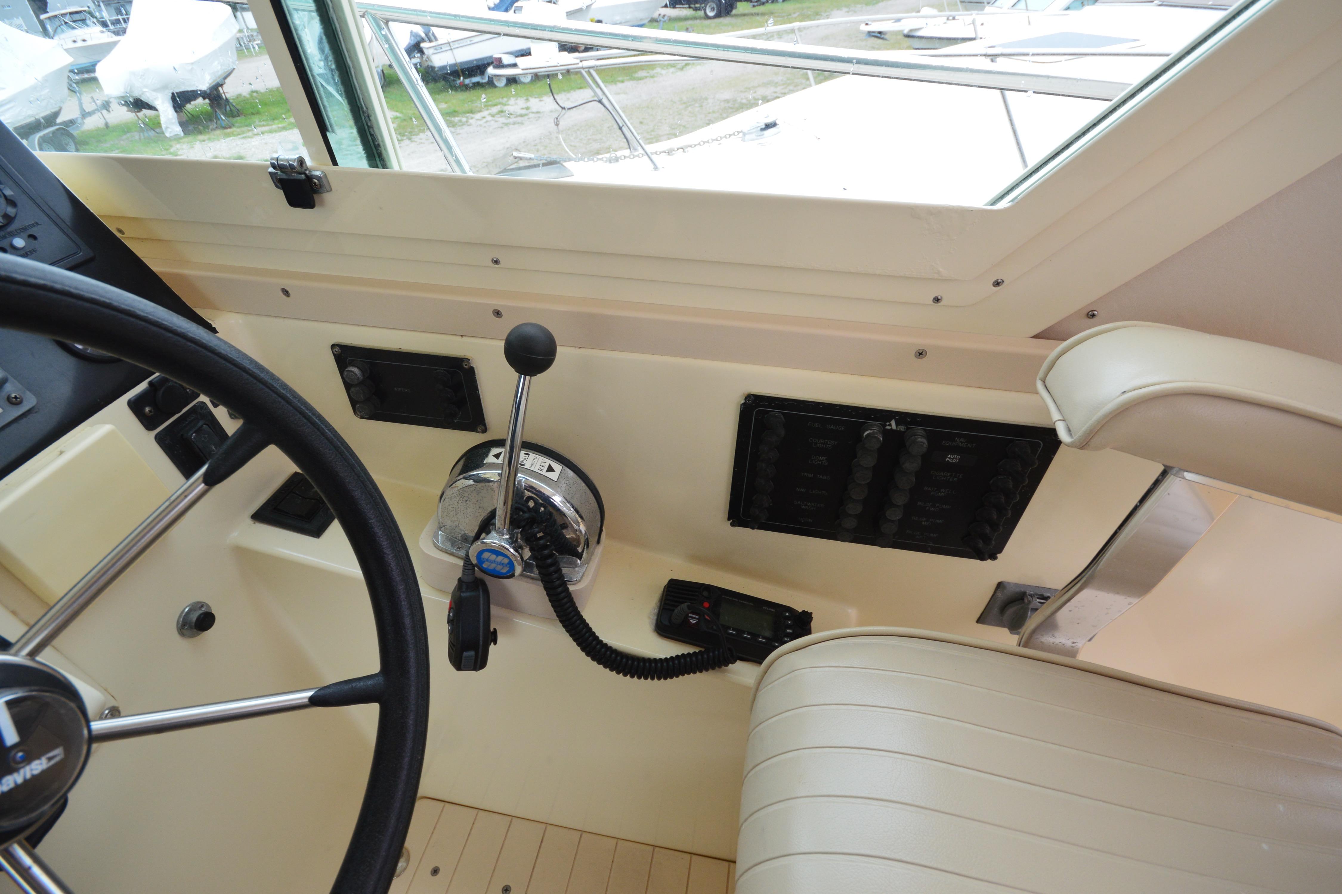 Interior helm of 2001 Albin 28 Tournament Express boat with steering wheel and controls.
