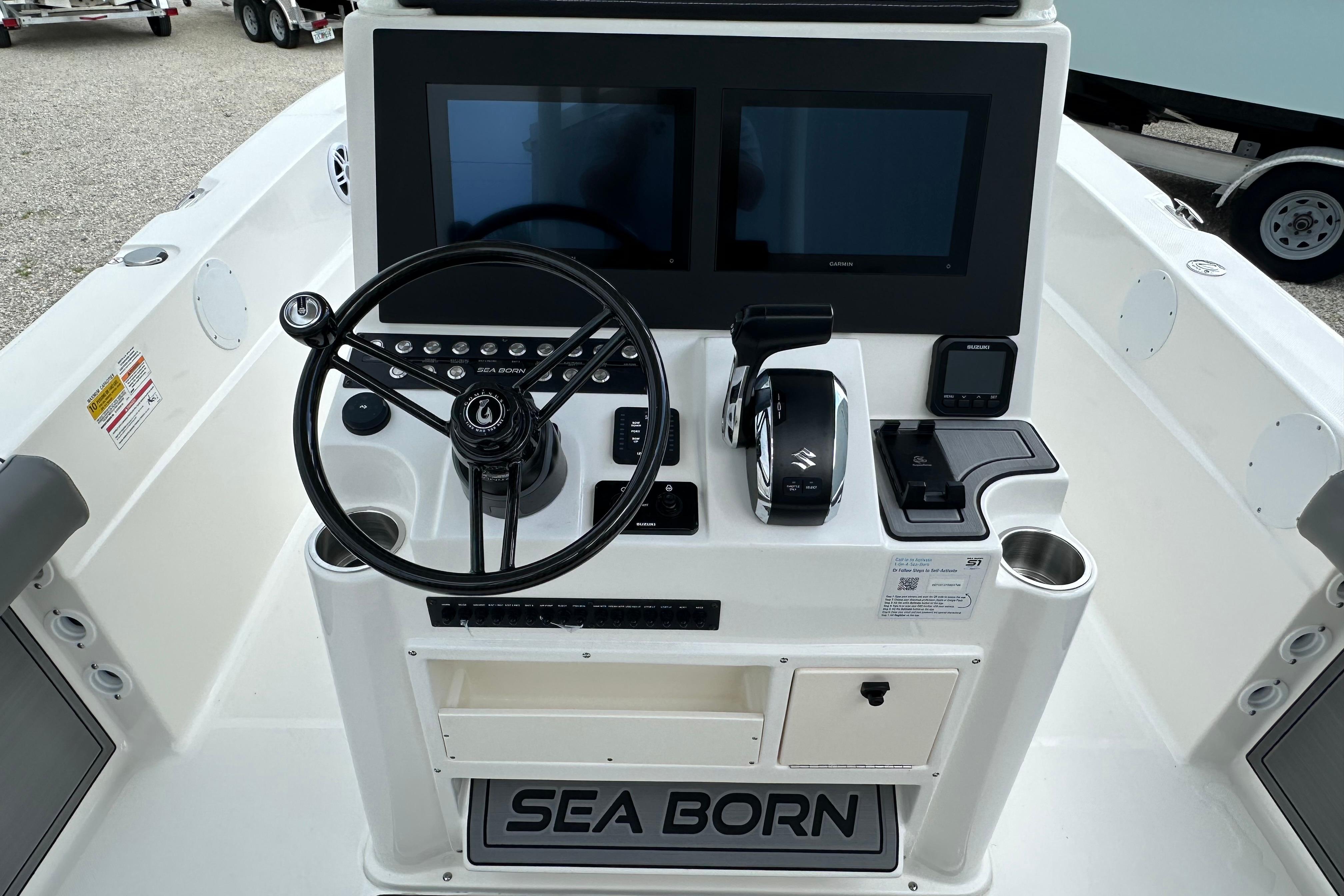 2027 Sea Born LX24 Center Console boat dashboard with dual screens and steering wheel.