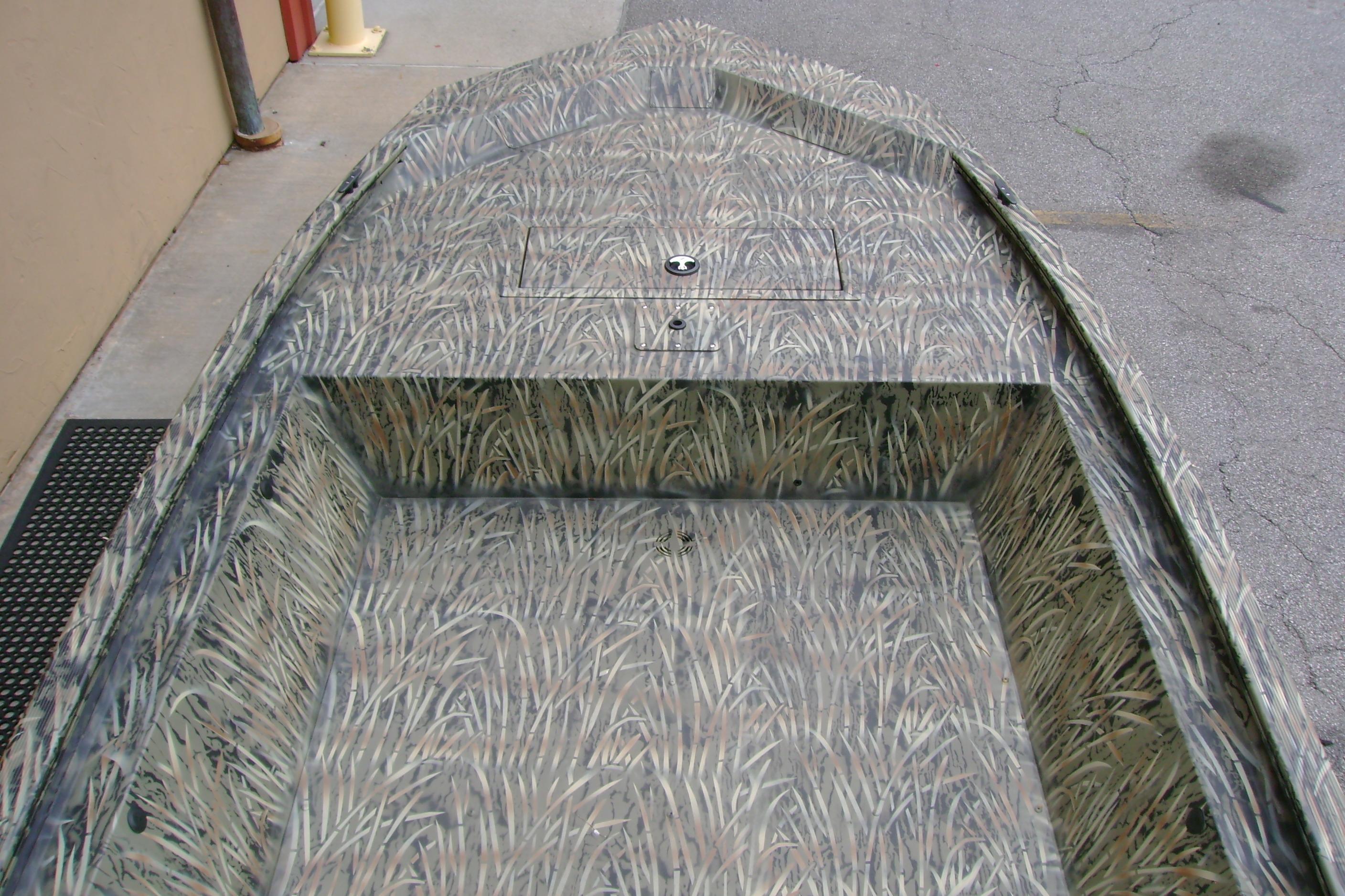 2026 Tracker Grizzly 1648 Utility boat with camouflage interior design.