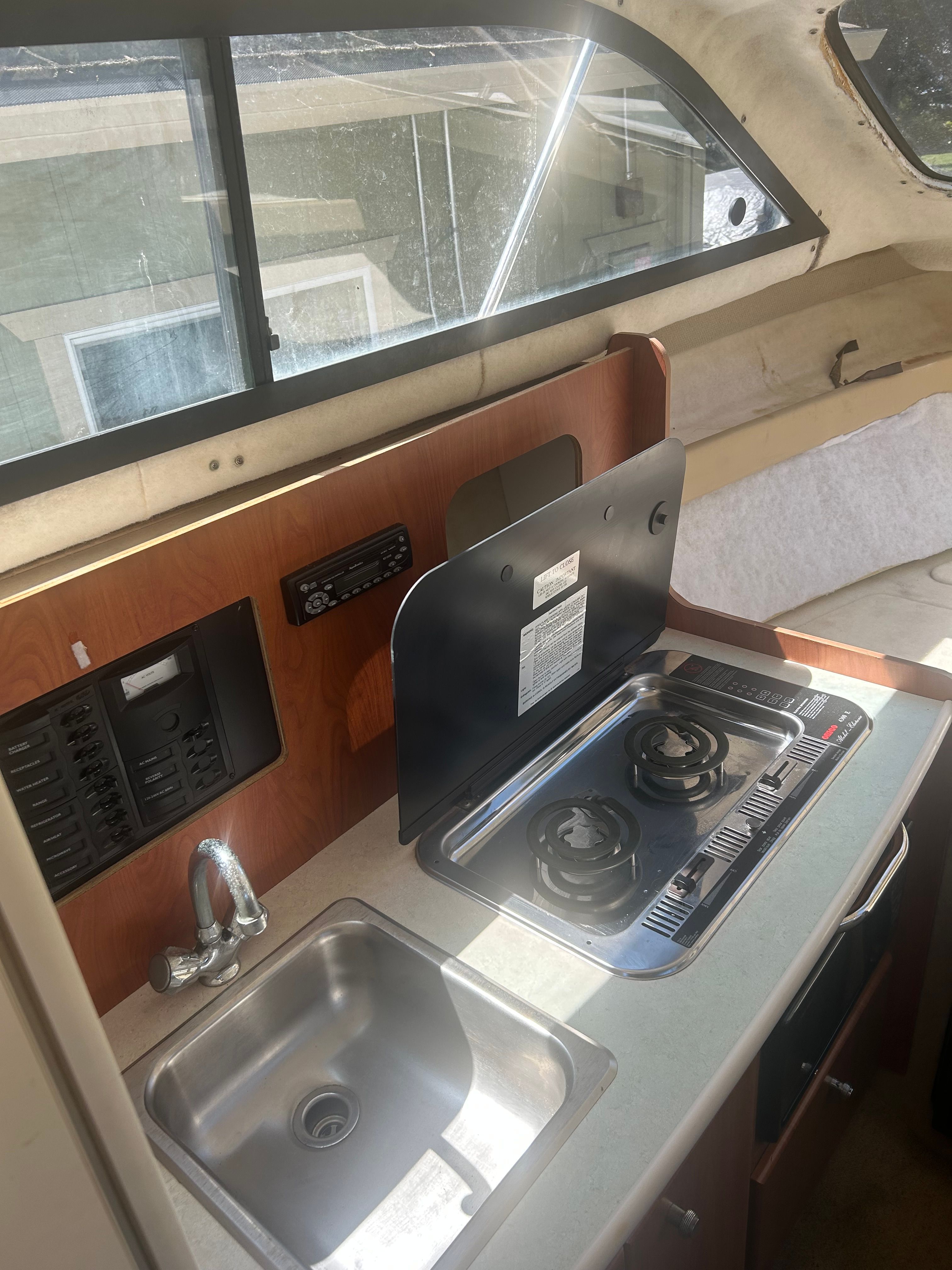 Interior of 2005 Bayliner Classic 242 with kitchenette.