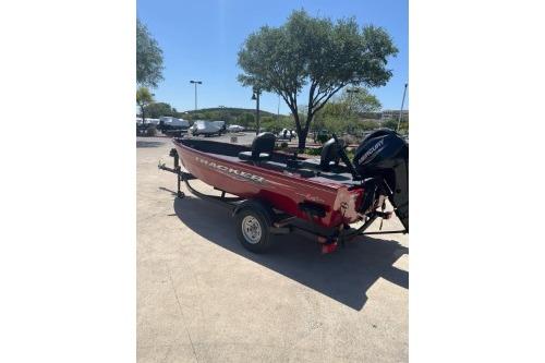 2025 Tracker Super Guide V-16 T boat on trailer, parked outdoors.