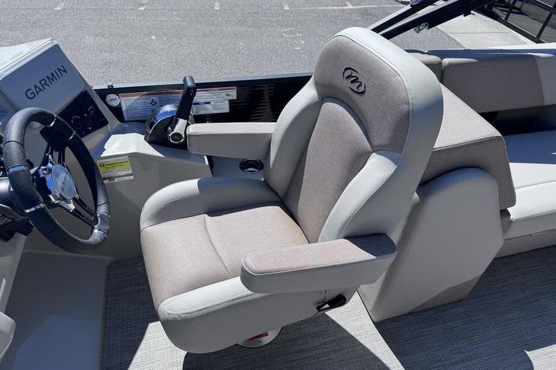 Captain's seat of 2027 Manitou Aurora 23 RF SHP boat with Garmin controls.
