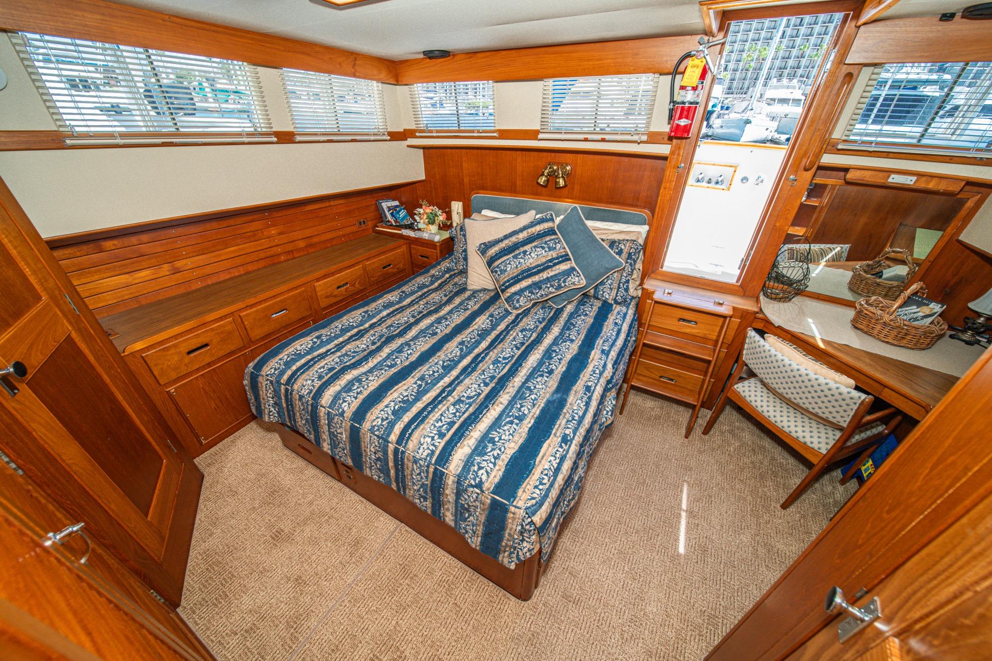 Cozy cabin interior of 1987 Grand Banks 46 Classic yacht with wood paneling and nautical decor.