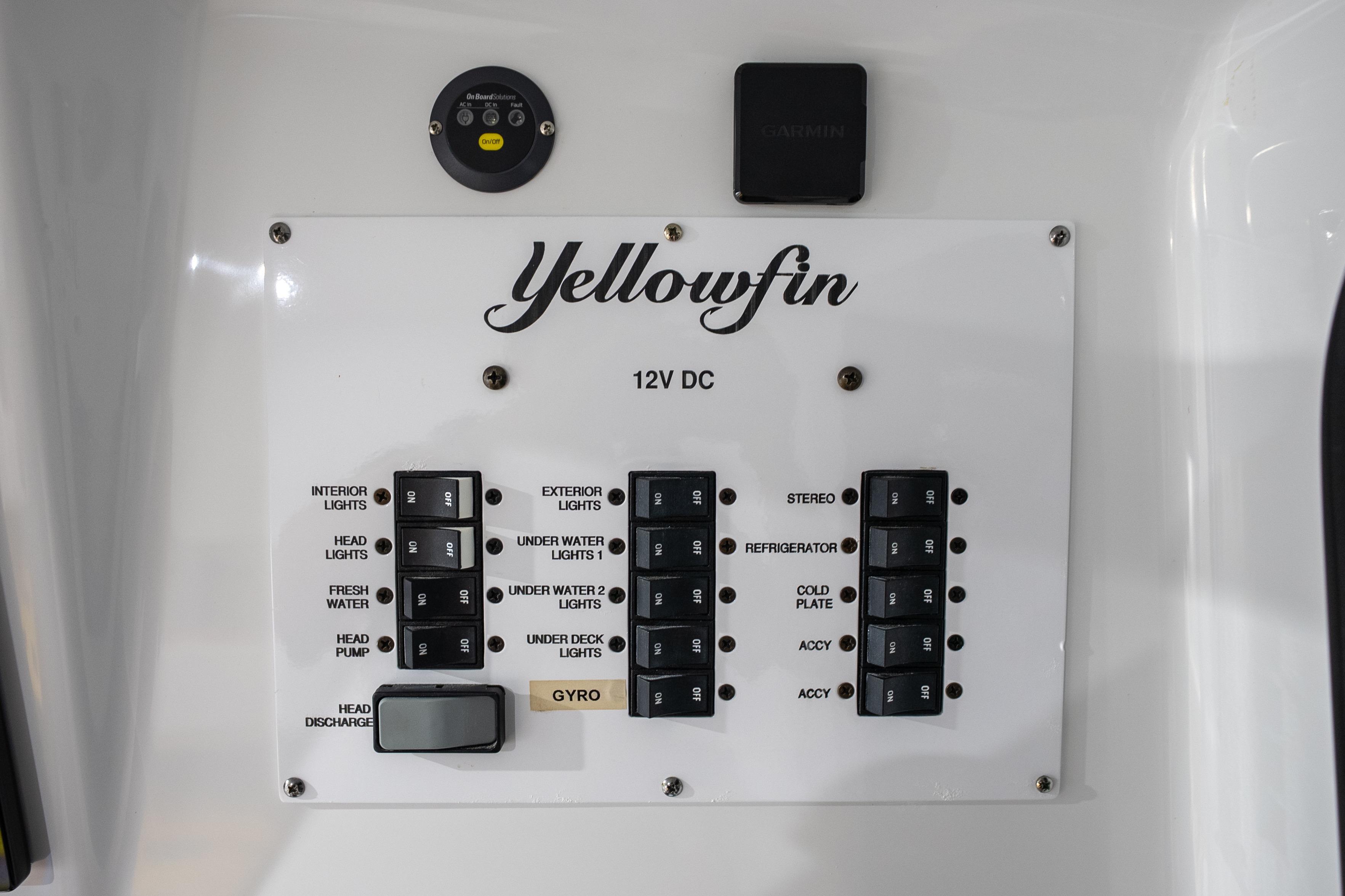 Control panel of 2023 Yellowfin 42 Offshore boat with labeled switches and buttons.