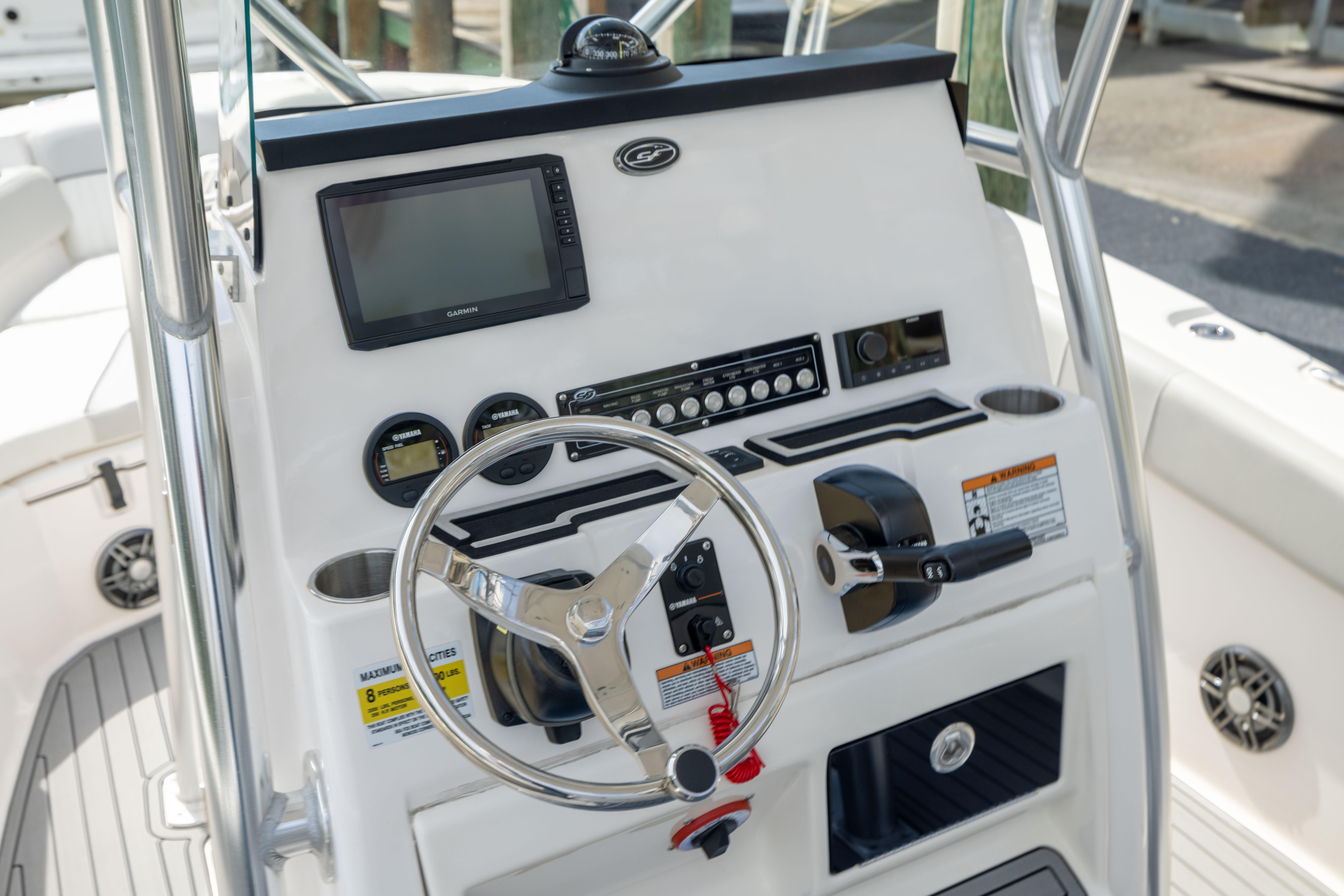 2023 Sea Fox 228 Commander boat console with steering wheel and navigation controls.