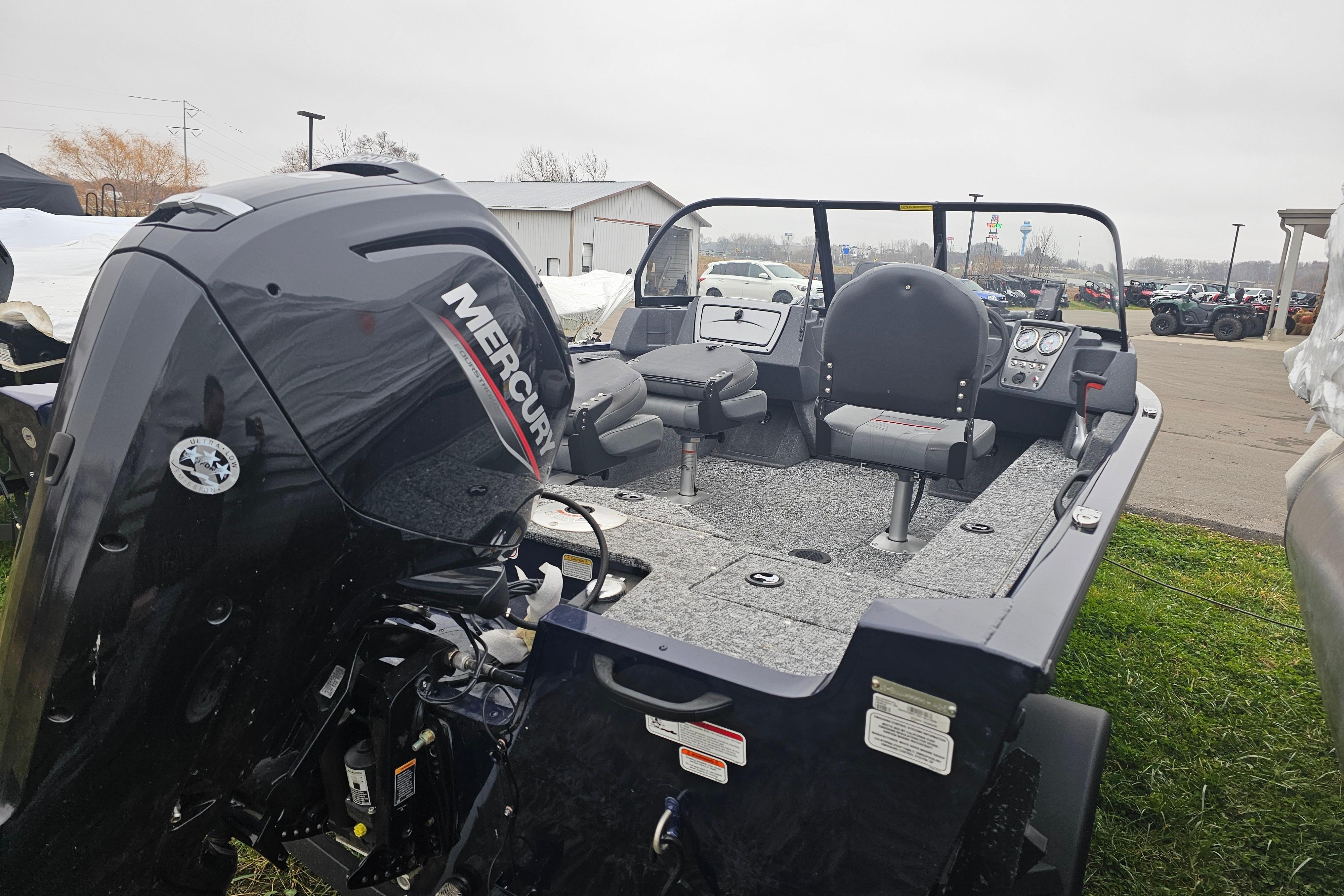 2025 Tracker Pro Guide V-16 WT boat with Mercury engine, parked outdoors.