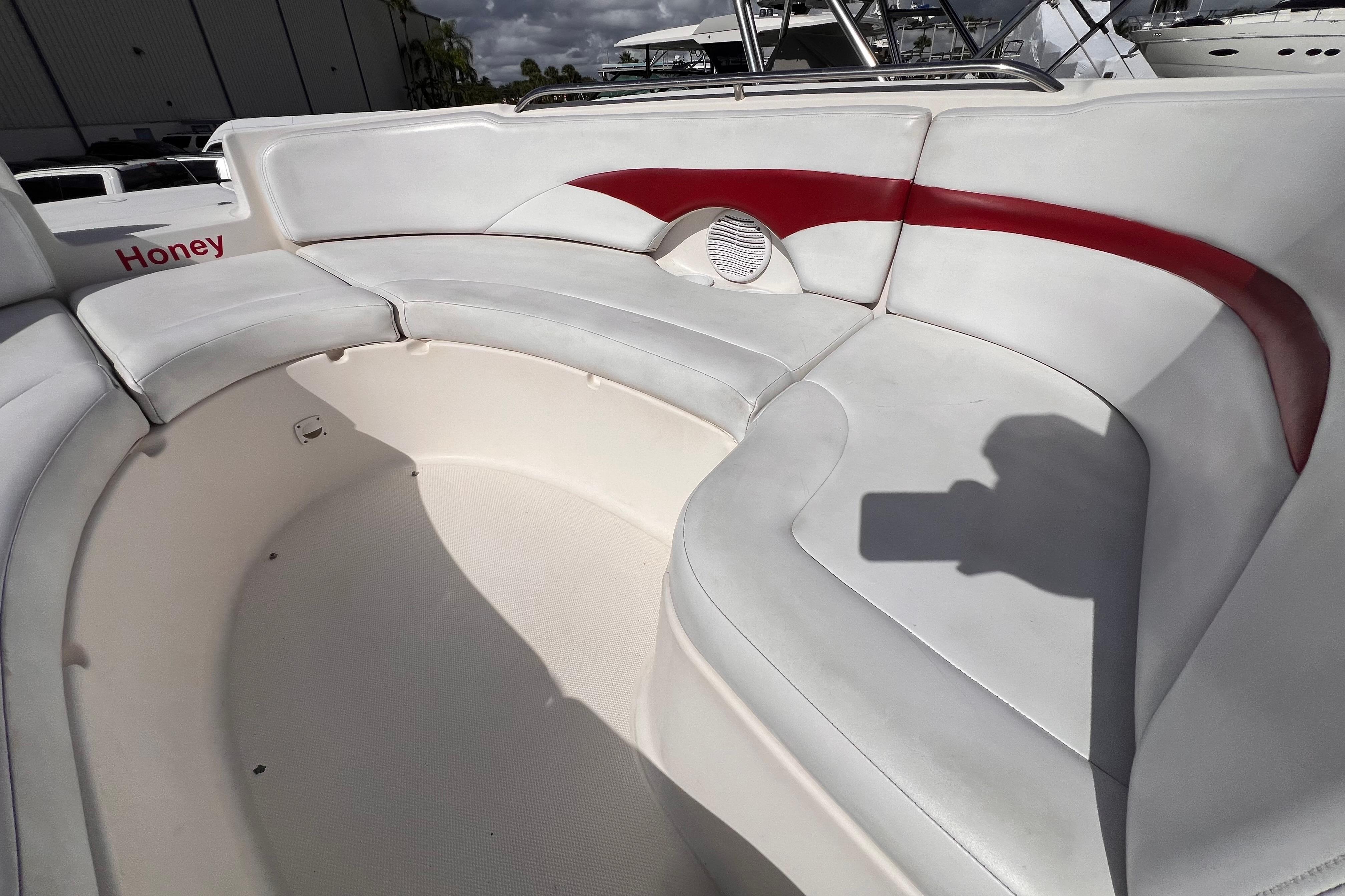2002 Chaparral 232 Sunesta boat interior with white and red seating.