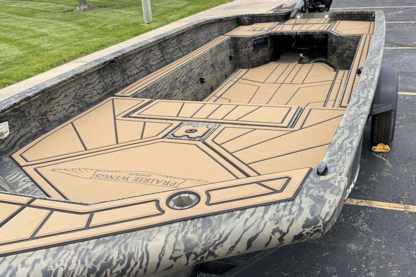 2026 Tracker Grizzly 1650 T Prairie Wings Edition boat with camo design and spacious deck.