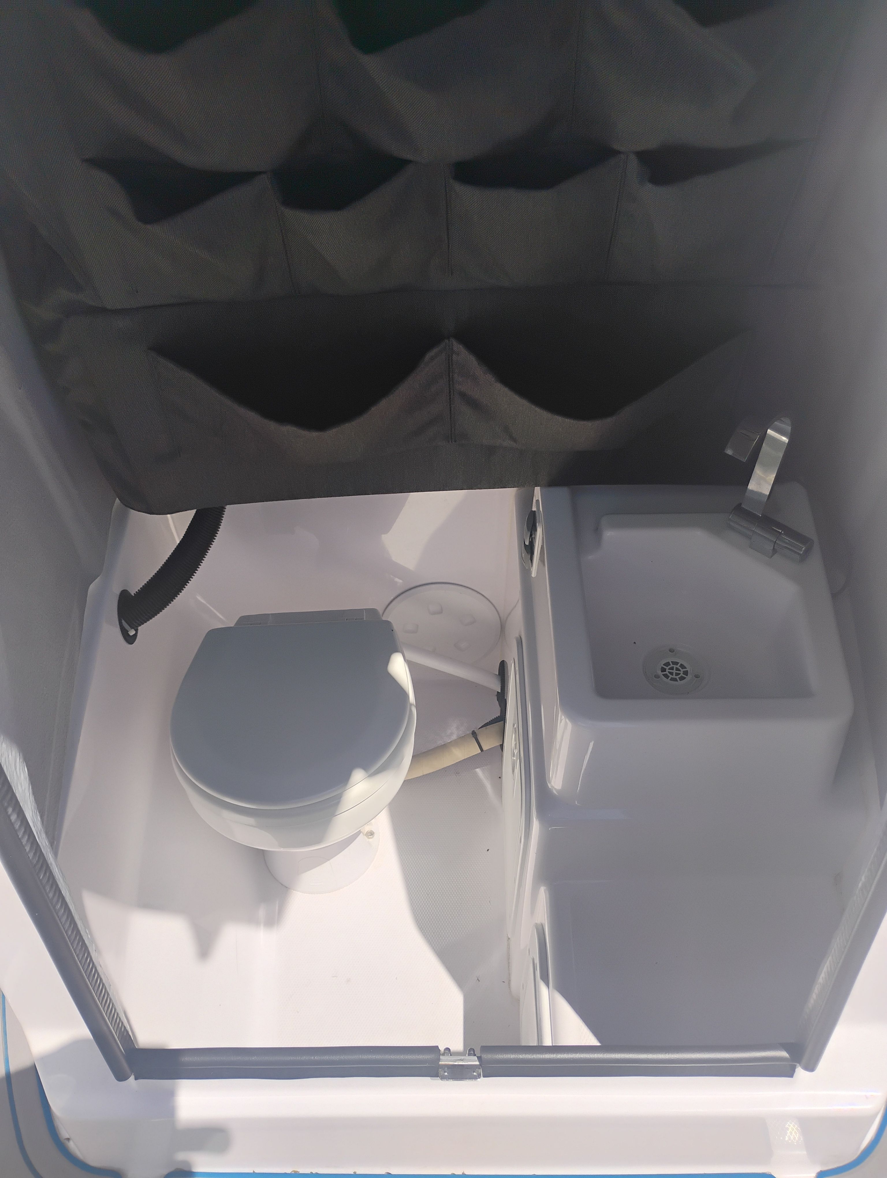 Interior of 2022 Axopar 22 T-Top featuring toilet and sink.