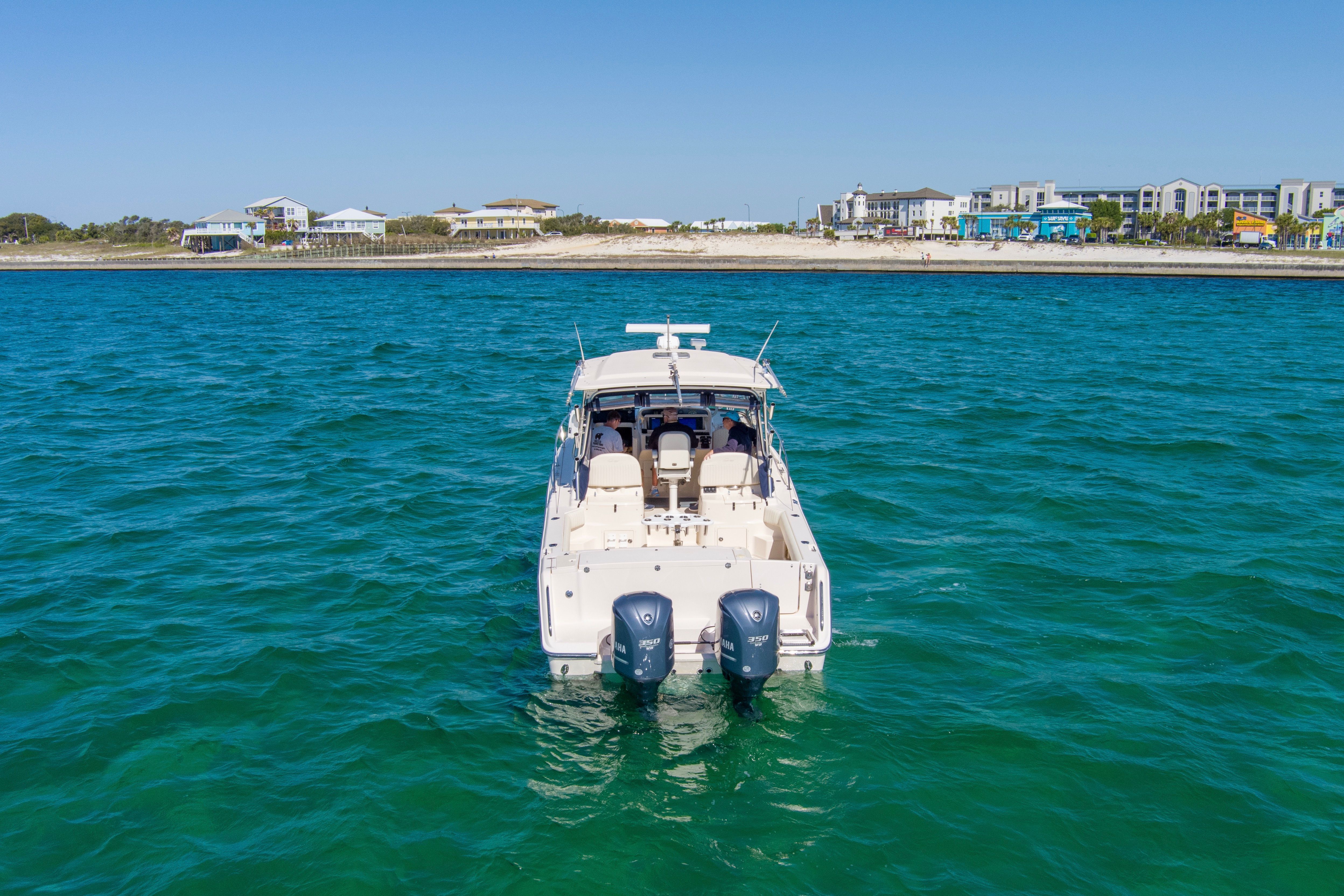 Grady-White Express 330 boat on water, coastline in background.