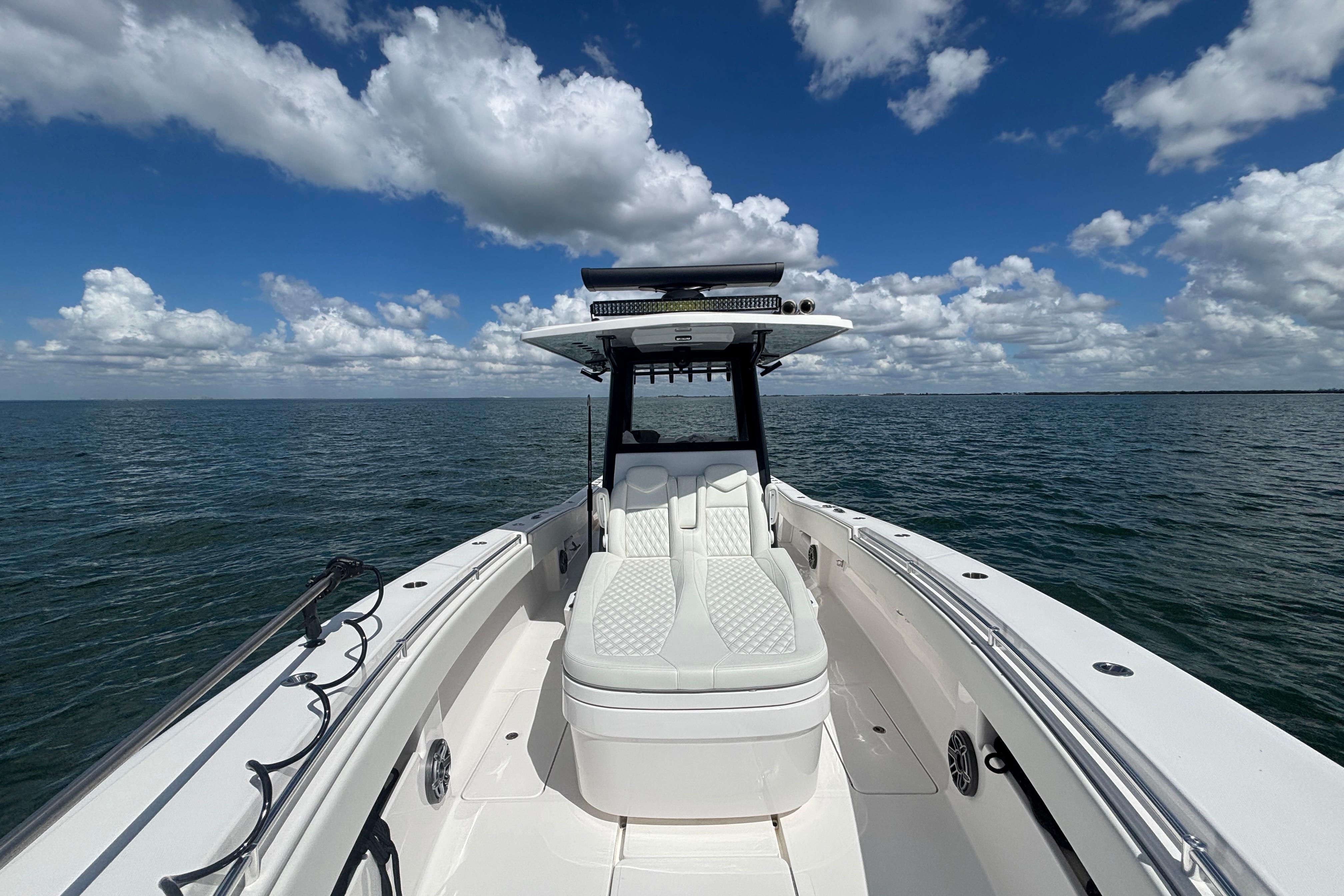 2024 Invincible 36 Open Fisherman boat on open water under a cloudy sky.