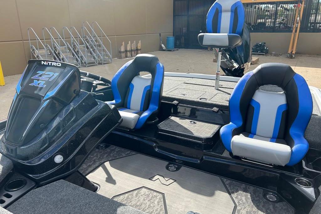 2026 Nitro Z21 XL Pro boat with blue and gray seating, parked outdoors.
