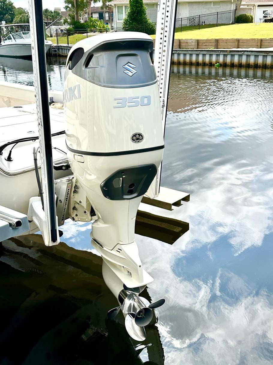 2020 Blue Wave 2800 Pure Hybrid boat with Suzuki 350 outboard motor on a calm waterway.