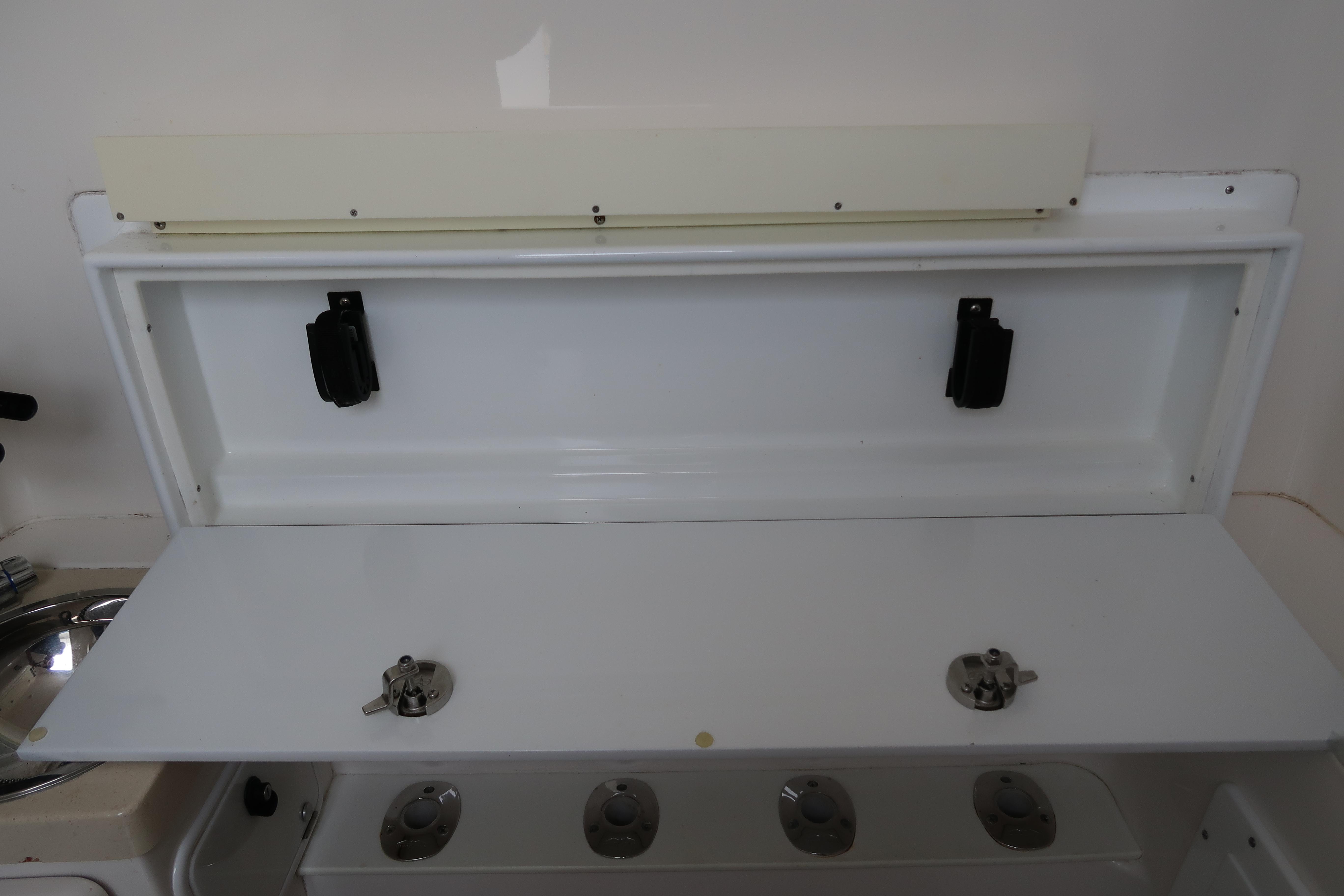 2016 Invincible 42 Open Fisherman storage compartment with rod holders.
