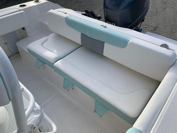 2024 Robalo R202 Explorer boat interior with cushioned seating and outboard motor.