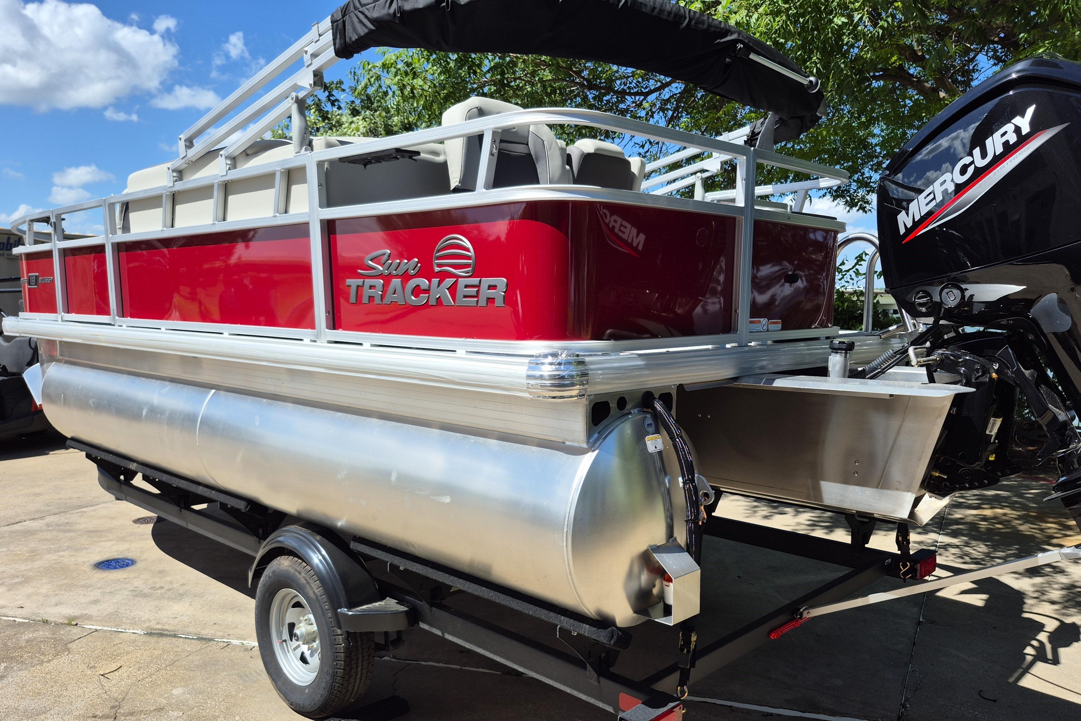 2026 Sun Tracker Bass Buggy 18 DLX pontoon boat with Mercury engine on trailer.