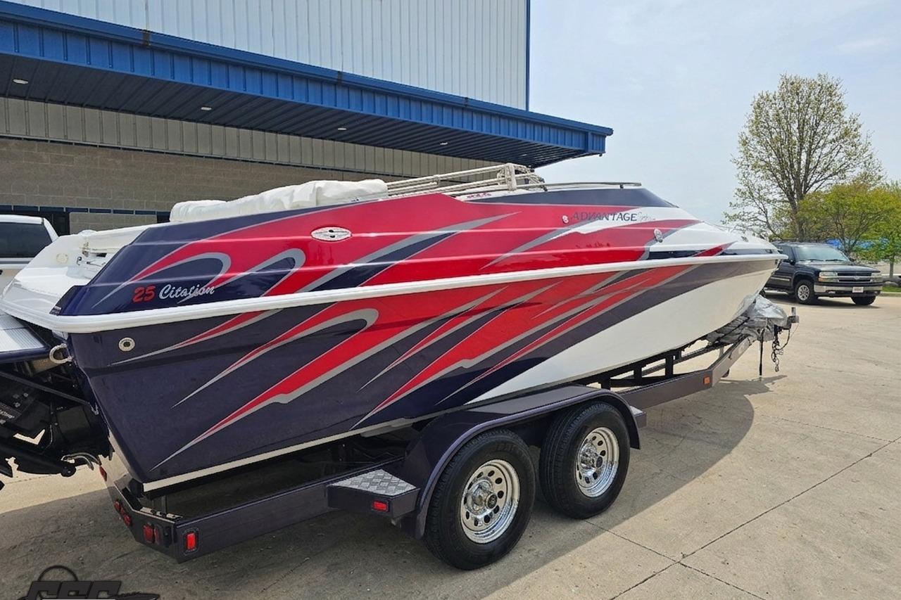2019 Advantage 25 Citation Bowrider with vibrant red and blue design on trailer.
