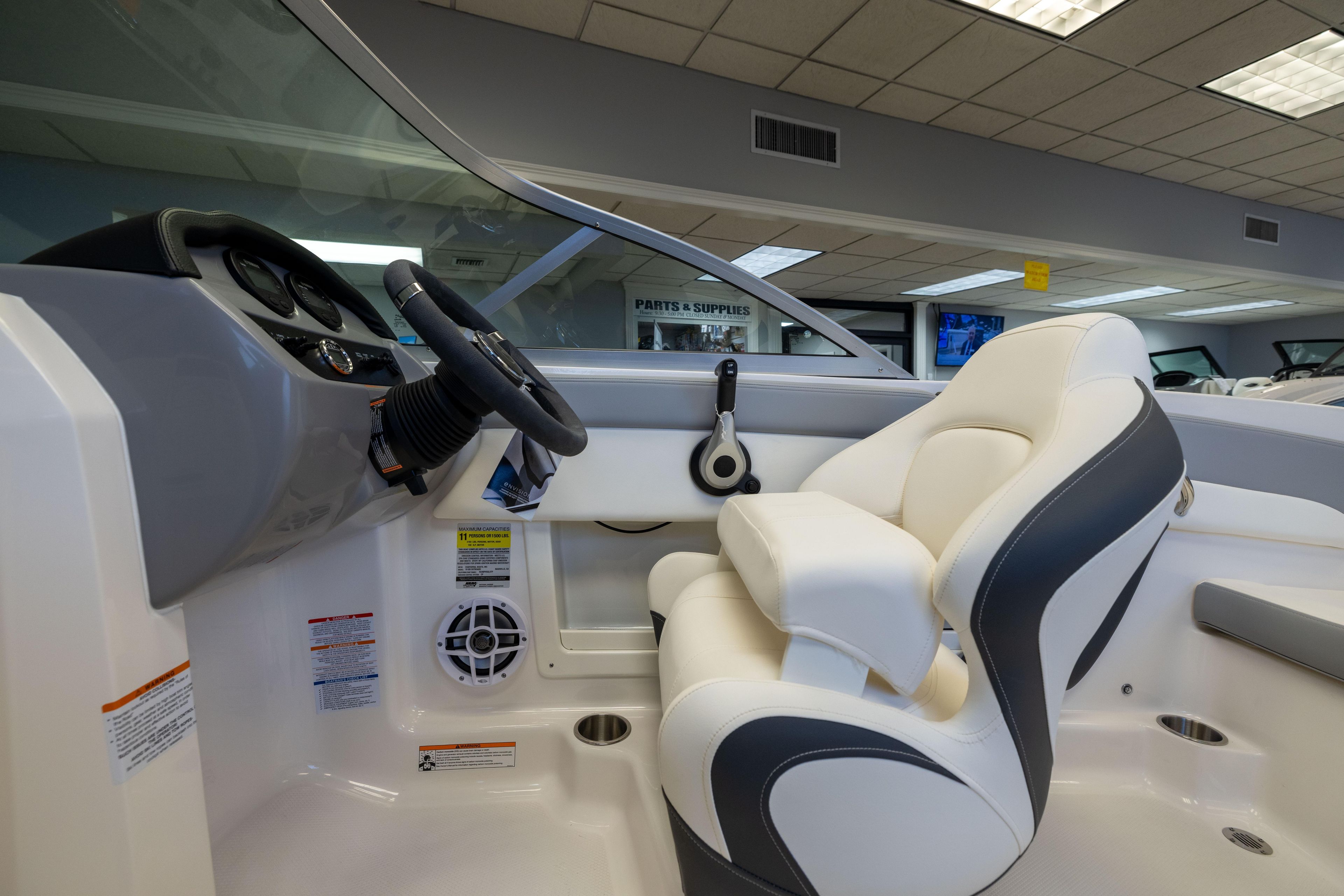 2024 Chaparral 19 SSi OB boat interior with steering wheel and comfortable seating.