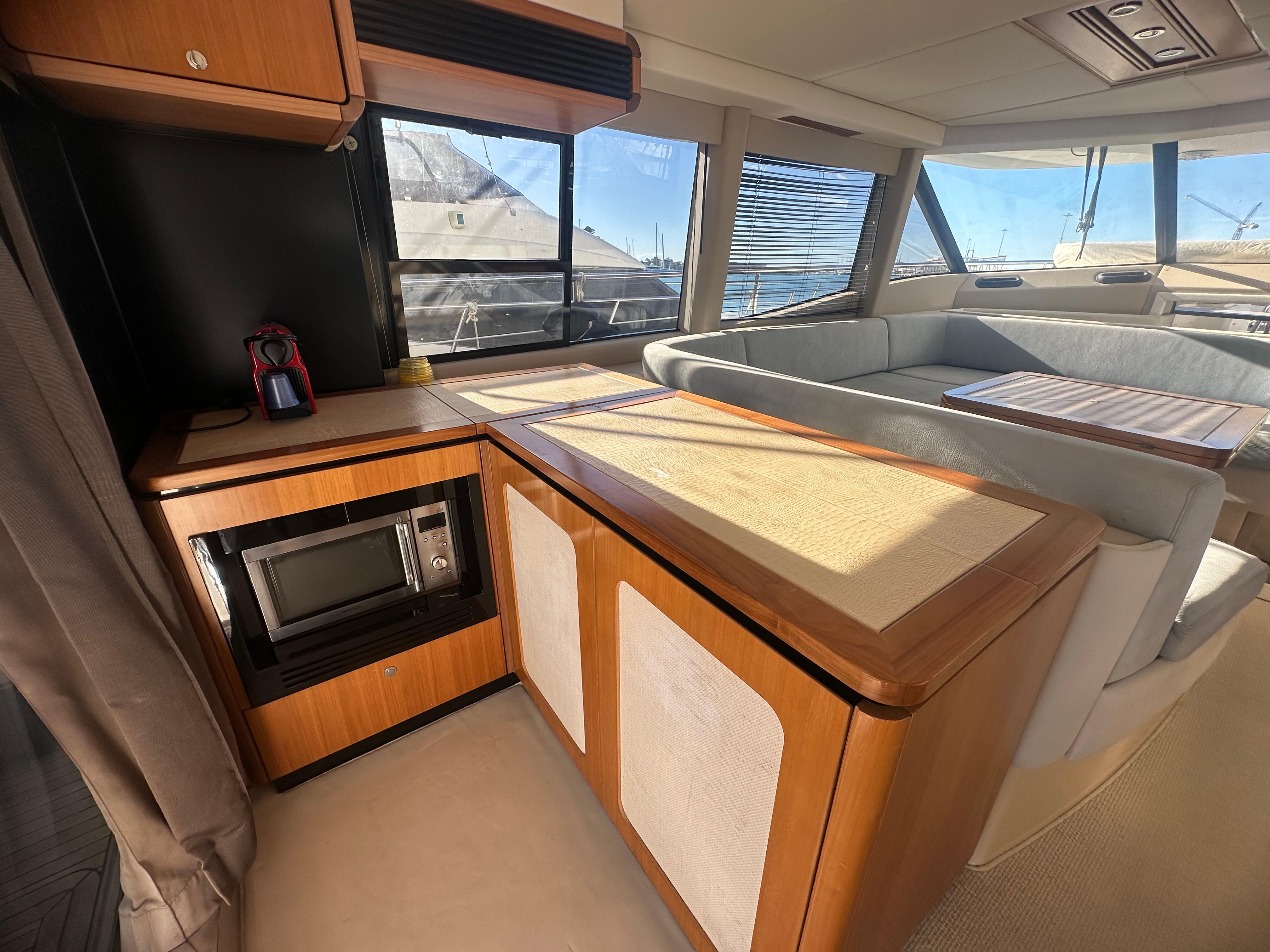 Luxurious interior of 2014 Azimut Magellano 50 yacht with modern kitchen and seating area.