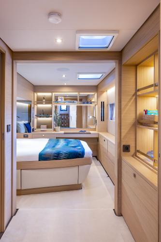 Luxurious interior of 2025 Lagoon 60 yacht with modern bedroom design.