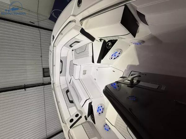 2025 Blackfin 272CC boat interior with modern seating and blue LED lighting.