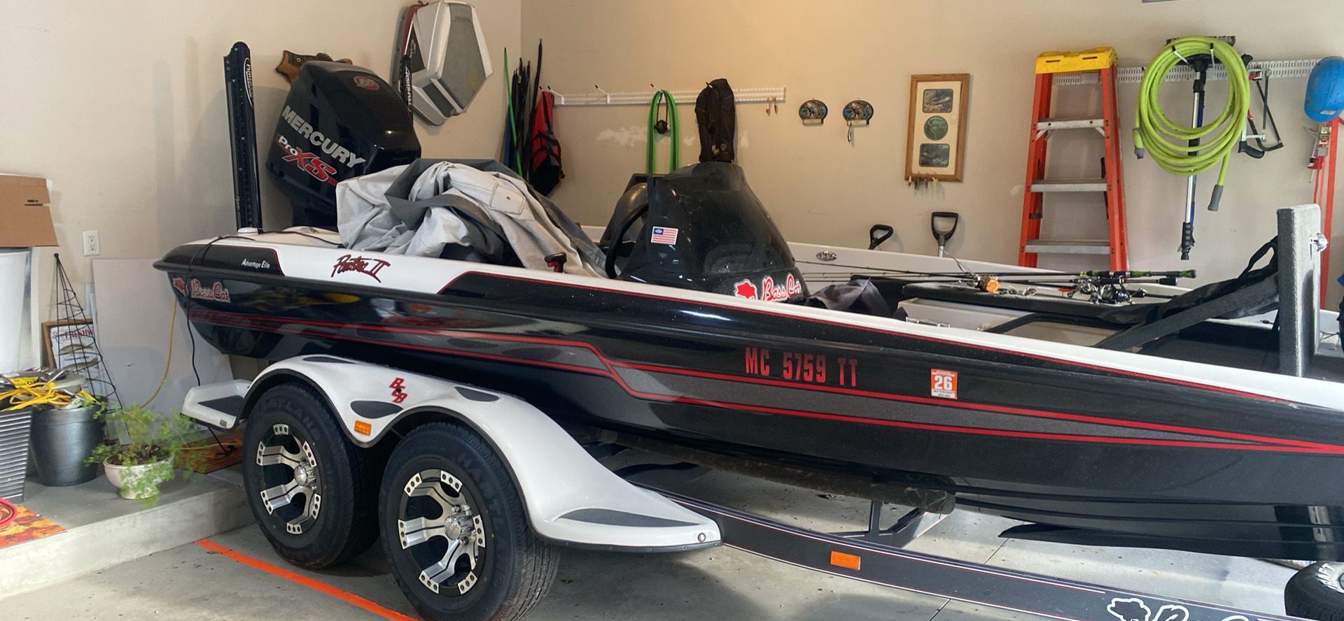 A 2014 Bass Cat Pantera II boat is parked in a garage on a trailer.