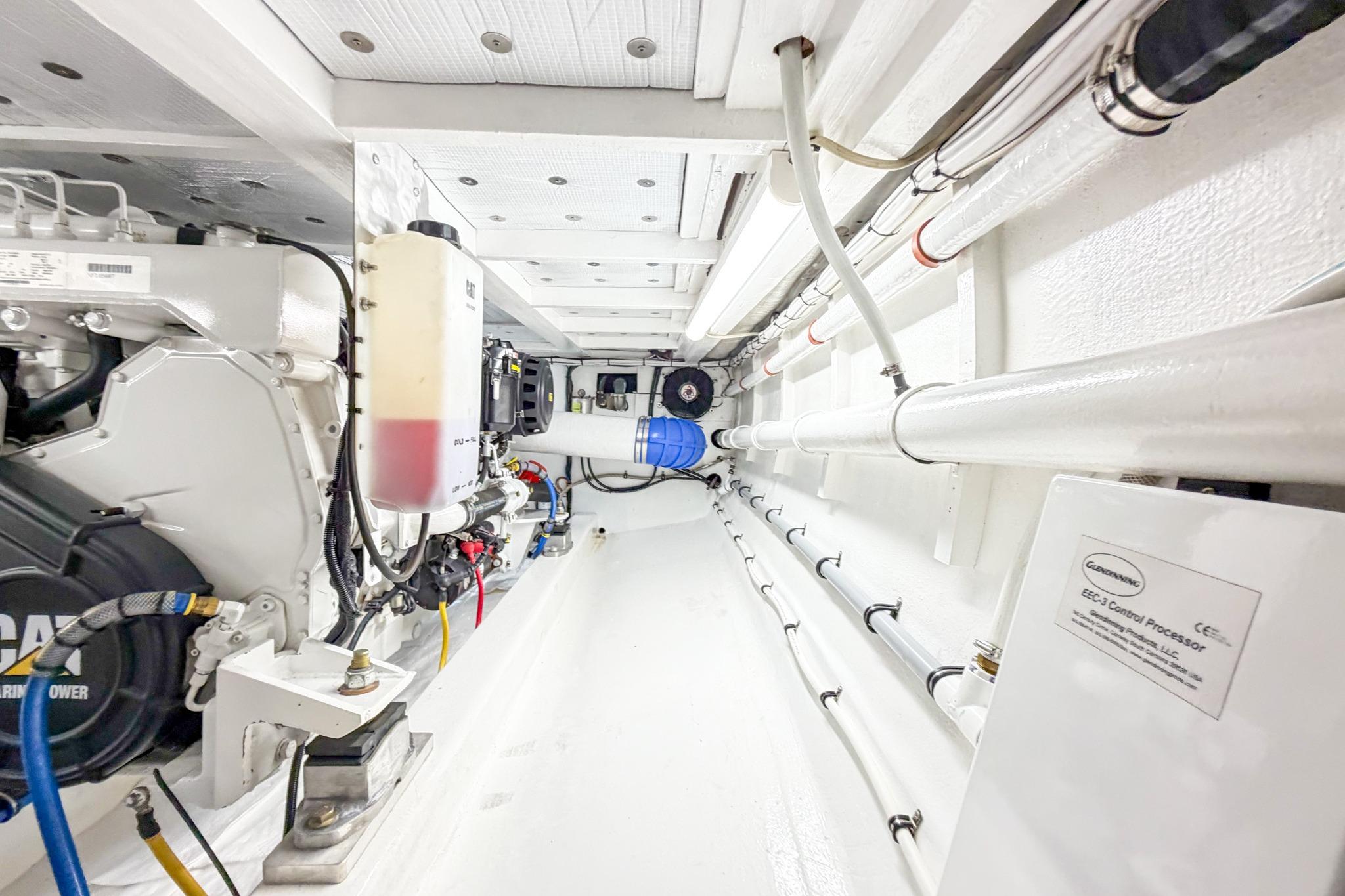 Engine room of 1998 Blackwell Custom Carolina Sportfish, showcasing mechanical components and piping.